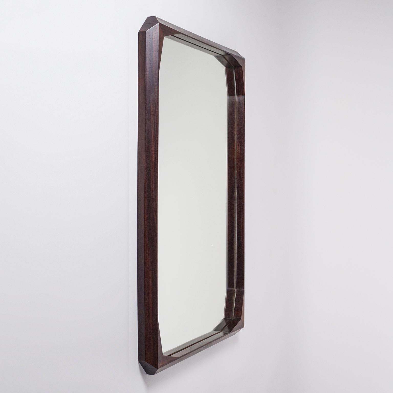 Rare Italian rosewood mirror by Dino Cavalli from the 1960s. The sculptural frame is made of solid rosewood and carved at various angles giving it a 'facetted' appearance. Very good original condition with just a few specks on the original mirror.