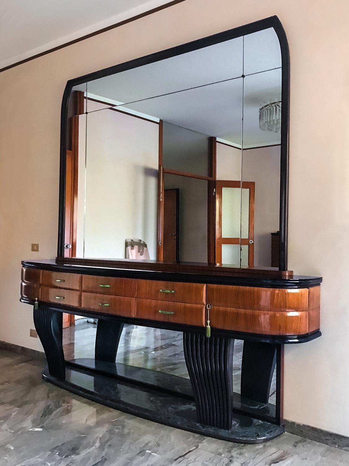 Important and very rare credenzas with mirror designed by Vittorio Dassi in the 1950s.
It’s a rosewood sideboard demilune shaped, with glass top in black opaline and equipped with six drawers finished crystal bevelled handles.
Two curved doors