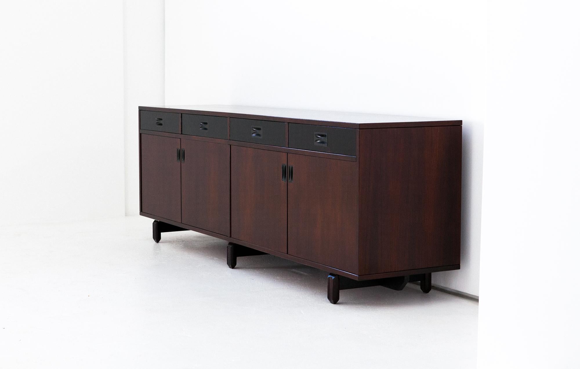 This credenza was manufactured in Italy during the 1960s by 'Stildomus'.
Has two compartment with four doors and four drawers. 

The cabinet is finished with a wood veneer, refined design milled legs and burnished brass handles

  