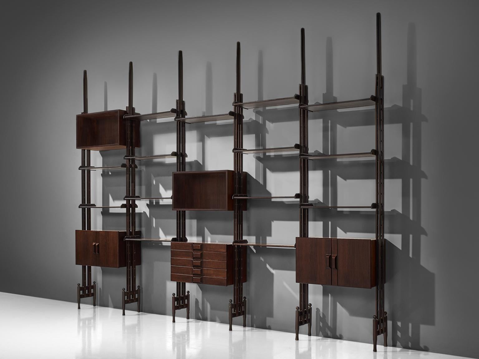 Large wall unit, rosewood, Italy, circa 1955.

This book shelf features five sections and three sections with cabinets. The This shelving unit is thus rather sections land the order and lay out of this unit is adjustable and can be placed