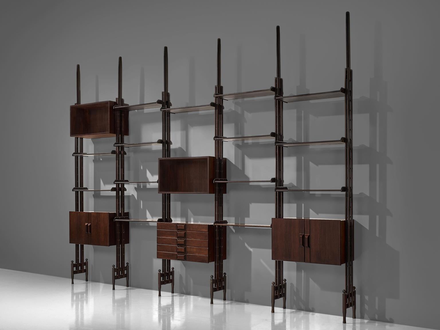 Large wall unit, rosewood, Italy, circa 1955.

This book shelf features five sections and three sections with cabinets. The This shelving unit is thus rather sections land the order and lay out of this unit is adjustable and can be placed