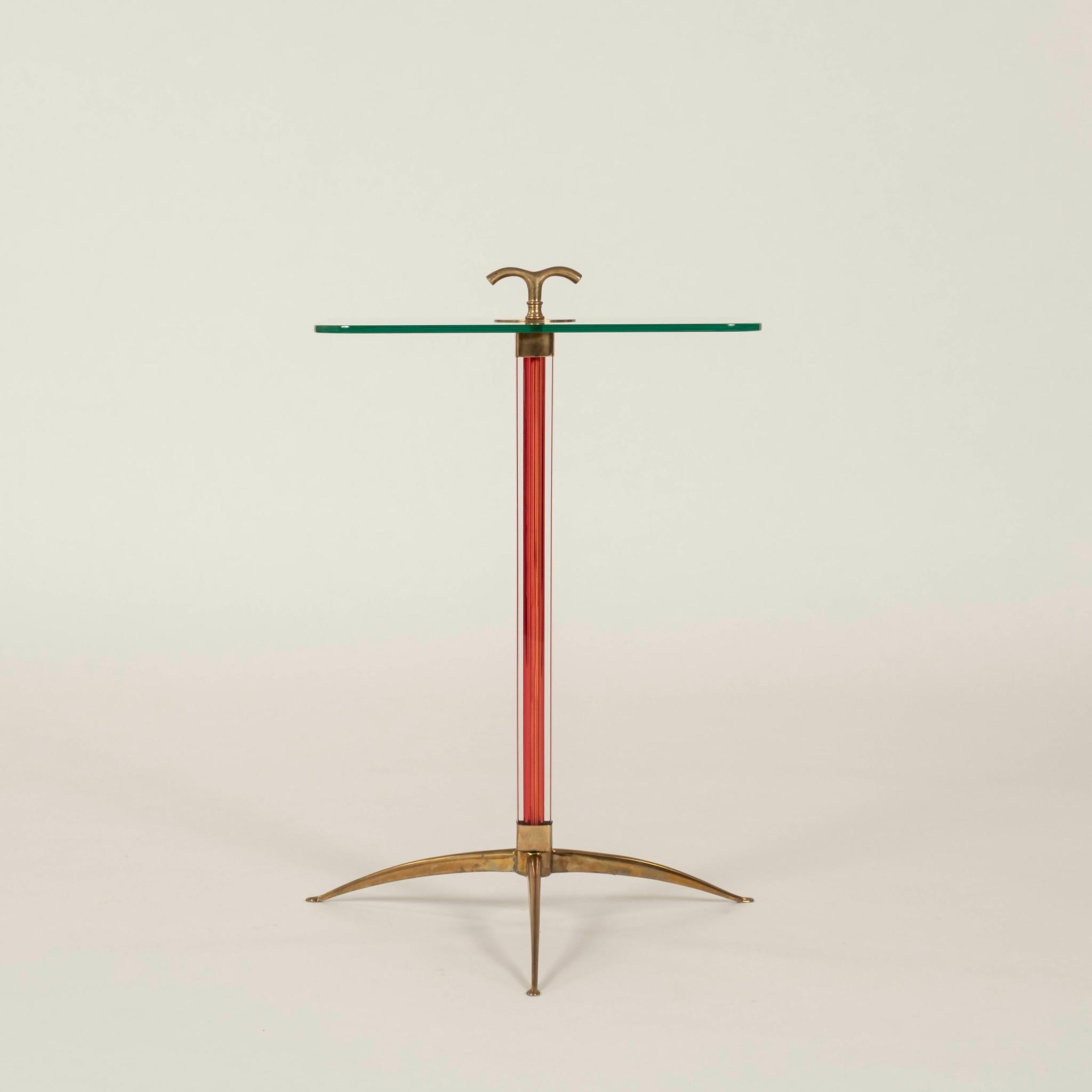 Chic and stylized Italian side table featuring a red Murano glass central column with a brass tripod base, square glass top, with a brass finial.