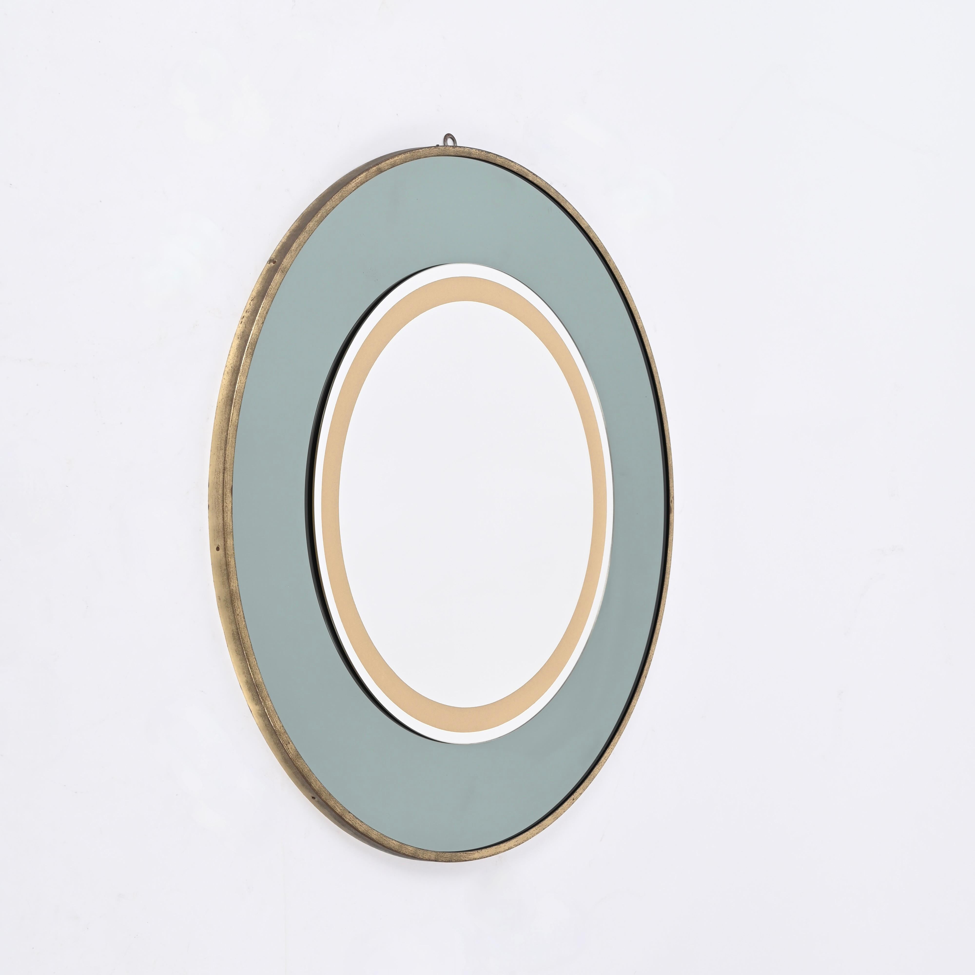 Majestic Italian round mirror with a sage green colored mirror and a clear one with a round gold decoration mounted over a brass frame. This incredibly elegant and rare mirror was designed by Cristal Art in Italy during the 1970s.

The round brass