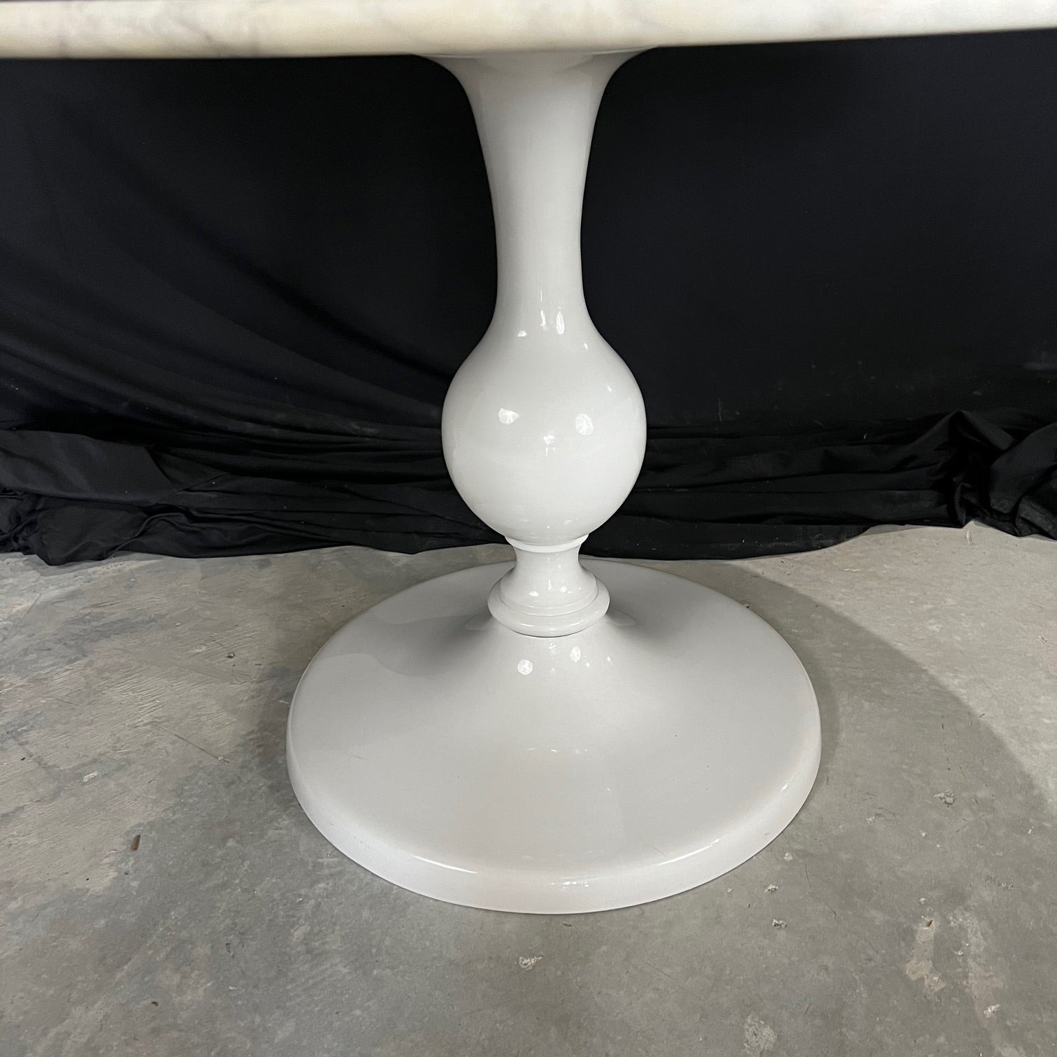 Modern but classic round marble top table in the style of Eero Saarinen but with a lovely metal enamel base pedestal table. Beautiful solid Italian Carrara marble with white and gray rustic veining to create a stunning piece of stone.  Resting upon