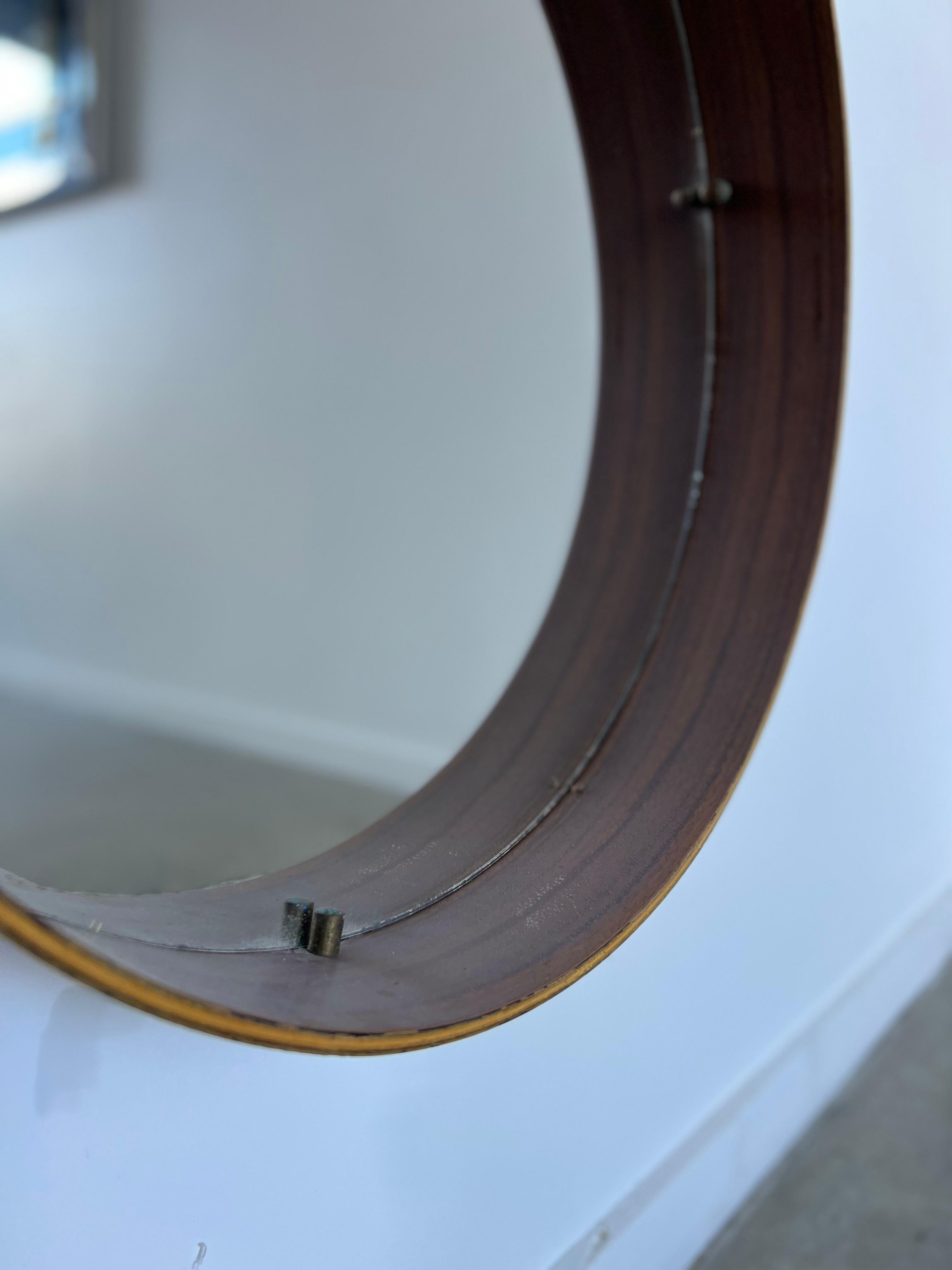 1950s Italian round mirror with rosewood frame.
Very stylish round Italian mirror made in timber, still in very good condition, original mirror glass.