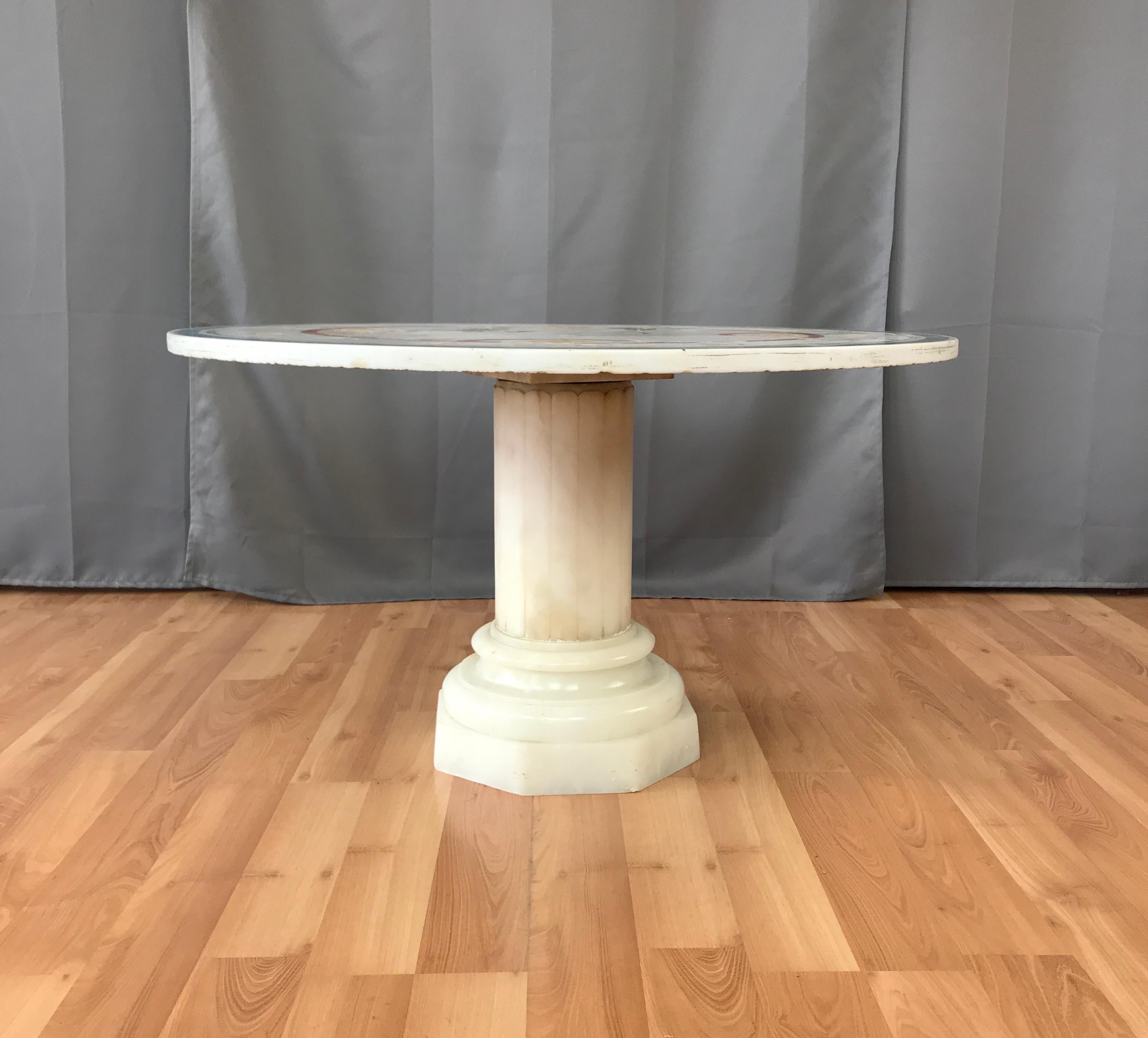 A vintage Italian round marble-top side or cocktail table, on a marble pedestal base. Painted inlay top, with rich colors. Would show well indoors or out.
Marked on it's underside made in Italy and ERLANGER N.Y.C.