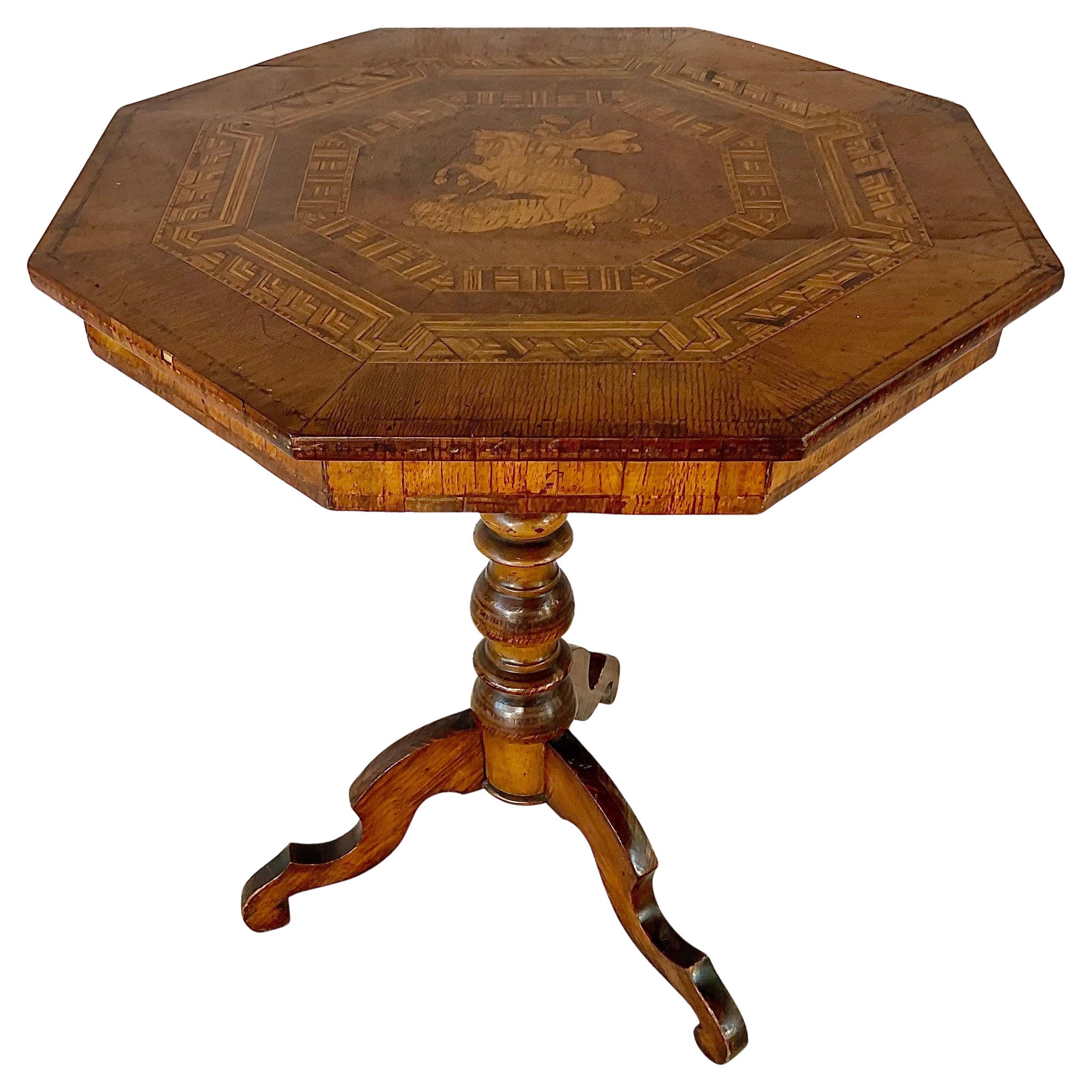 19th Century Italian Sorrento Side Table. Table features intricate geometric and figural marquetry inlay to the octagonal top. The central medallion depicts a classical scene of a soldier on horseback, slaying a dragon. The center is framed by