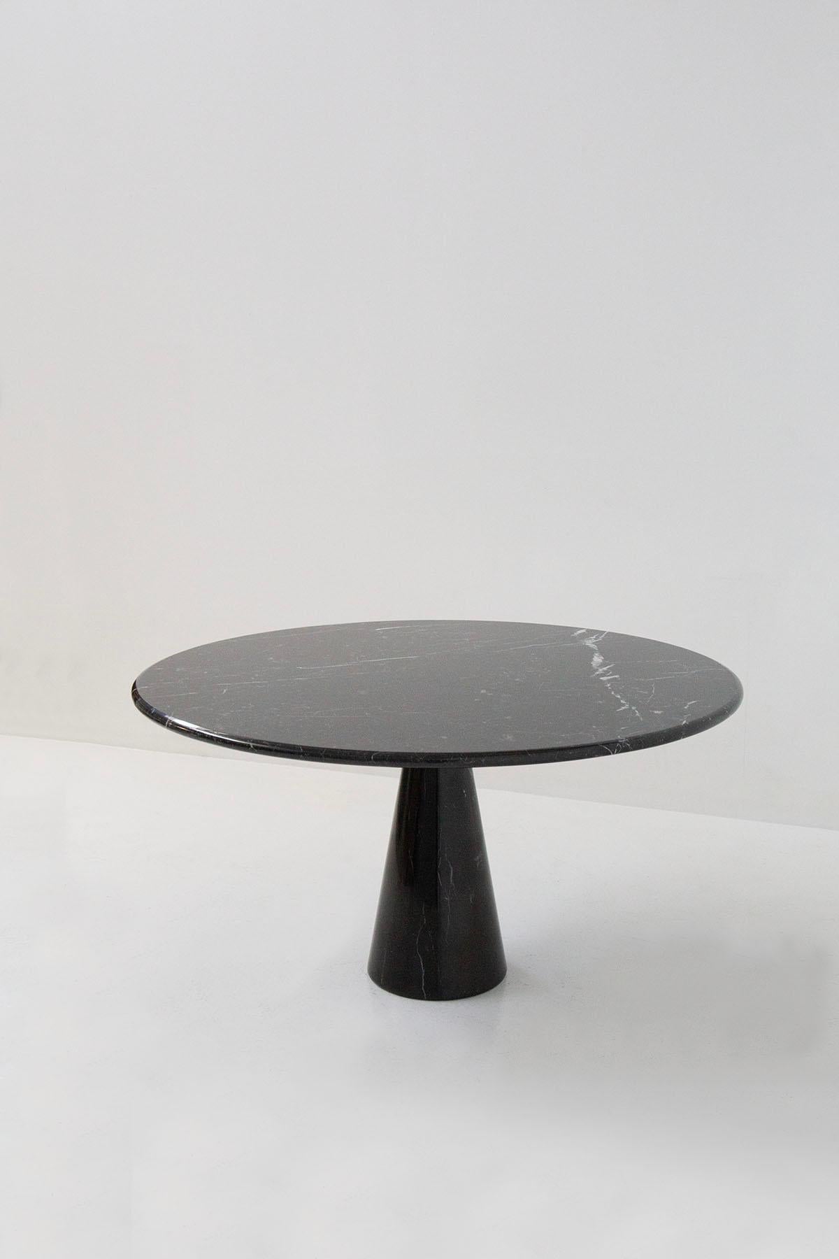 Imposing round table made of black Marquina marble design Angelo Mangiarotti. The table is made of two components: one is the pedestal base in a single block of marble and the totally round table top also made of a single block. In the table top we