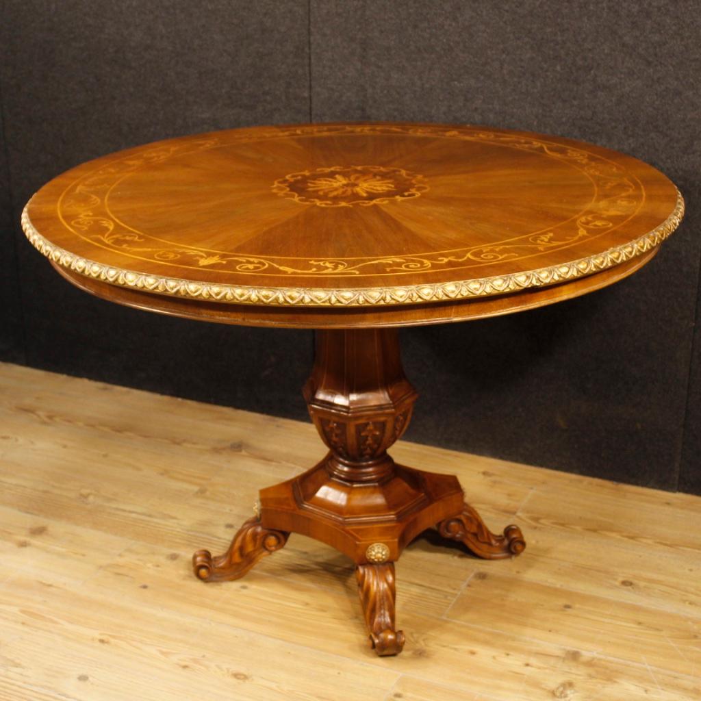 Italian center table from 20th century. Furniture carved and inlaid in walnut, burl, mahogany and maple of beautiful line and pleasant decor. Central leg table adorned with gilding elements. Furniture of good solidity and service in good state of