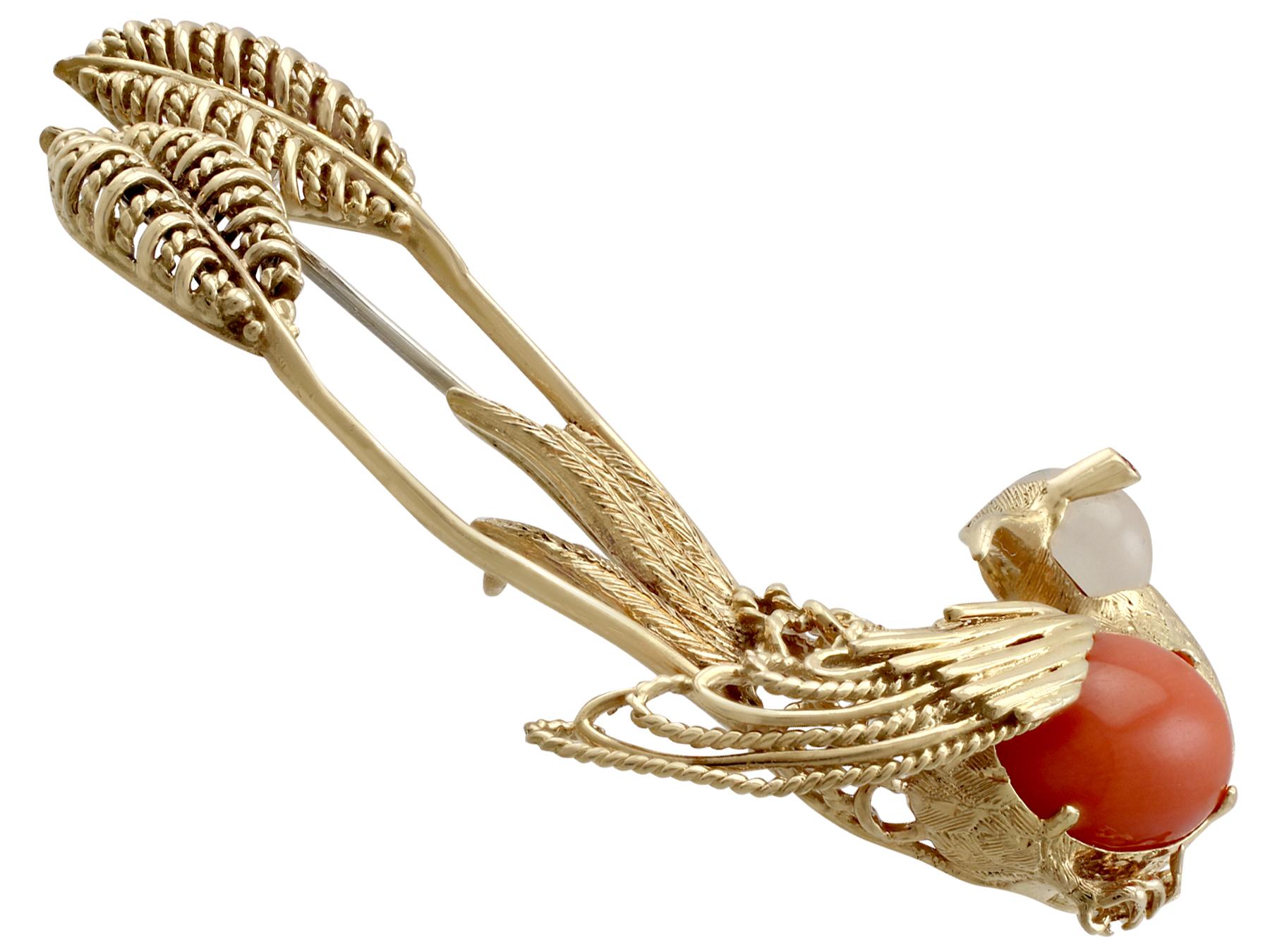 A stunning 0.03 carat ruby, 1.64 carat moonstone, coral and 18 karat yellow gold 'hummingbird' brooch; part of our diverse vintage jewelry collections.

This stunning, fine and impressive vintage bird brooch has been crafted in 18k yellow gold.

The