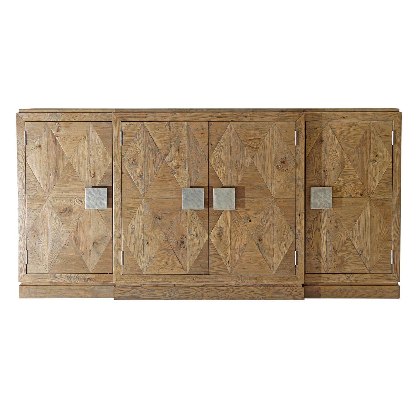 Italian Rustic Parquetry oak breakfront credenza with four doors having bold 'vintage' metal handles with three sections and interiors with adjustable shelves, the center section with a fixed drawer, and credenza raised on a plinth