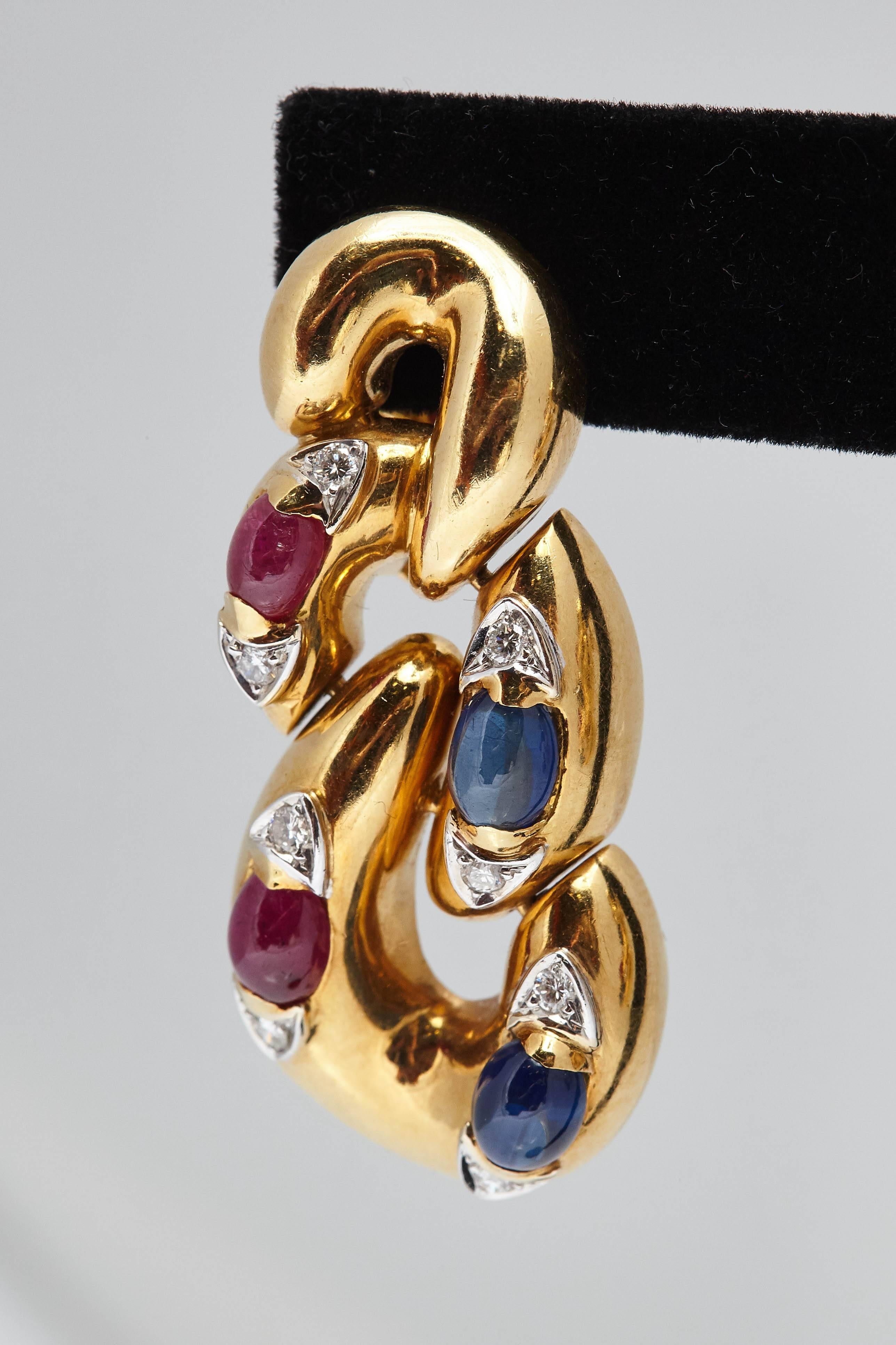 A pair of peculiar 18kt yellow gold ear pendants with cabochon sapphires, cabochon rubies and diamonds. Made in Italy, circa 1970s