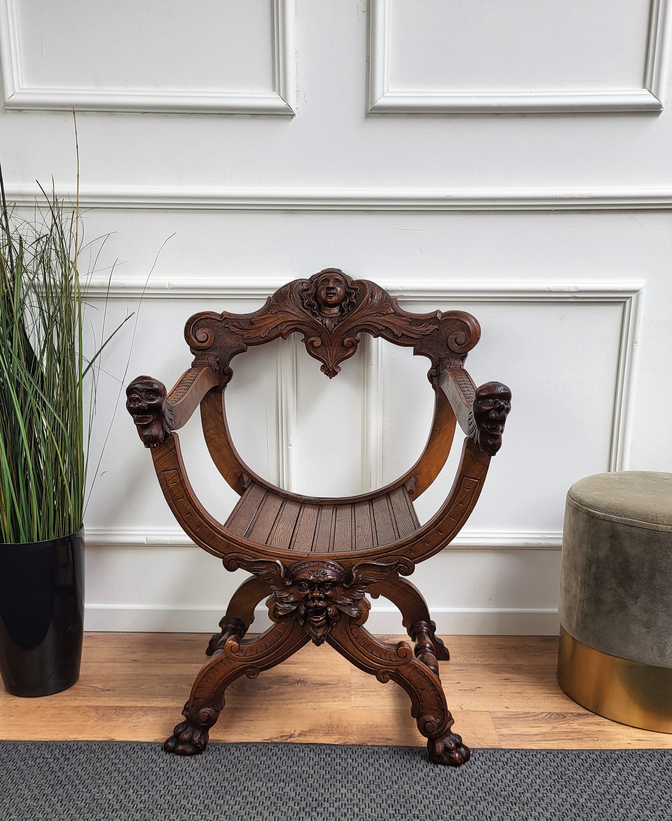 Beautiful Savonarola chair in amazingly carved walnut. The backrail, the armrests start and ending, the front and back feet, the central crossing are all decorated with incredibly hand-carved figures, mainly faces and heads with as well other parts