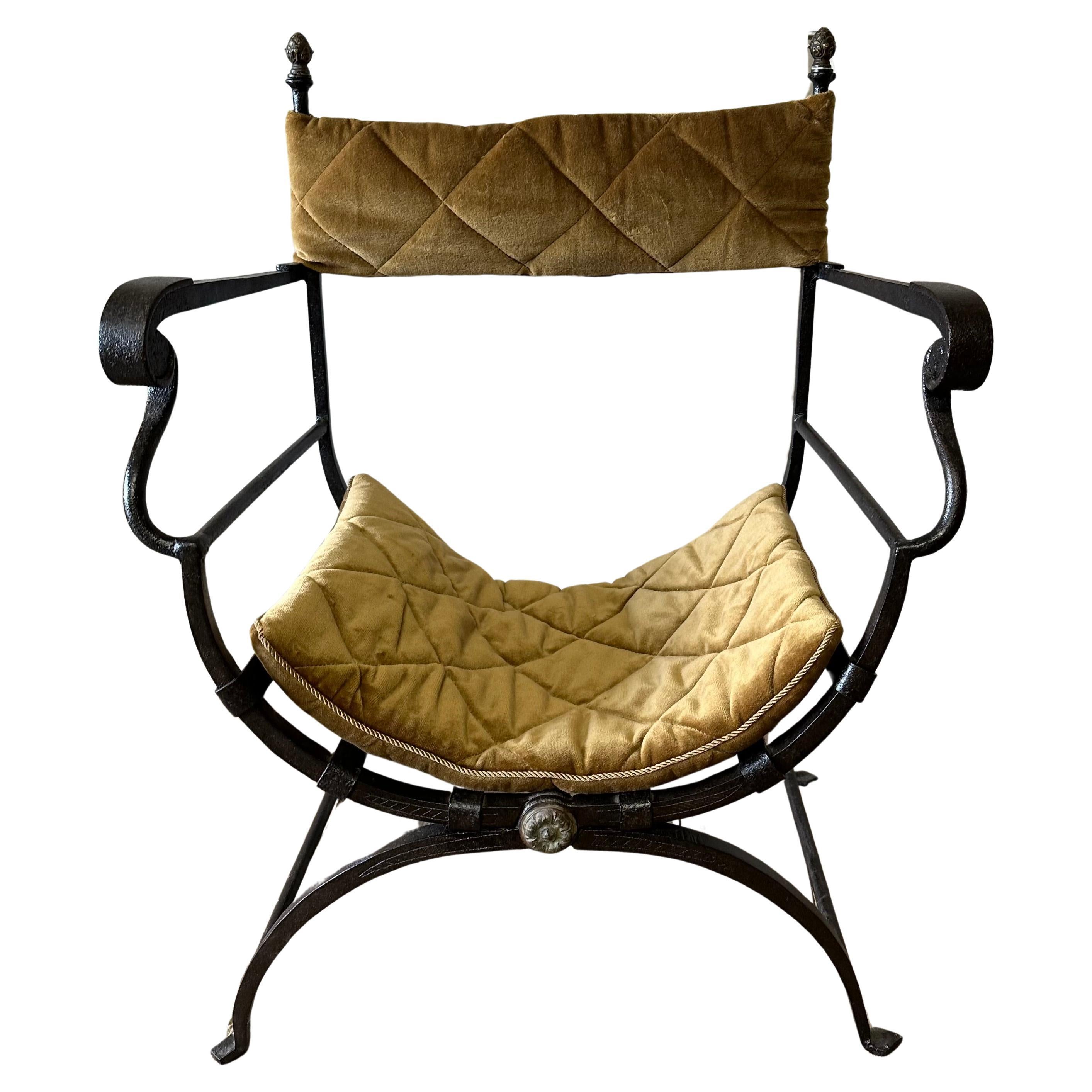 Stunning Italian iron Savonarola Dante chair also known as x chairs or Curule chairs. Featuring an iron frame that folds in a Campaign style with bronze-mounted finials. A sling back rest and cushion seat made of vintage quilted velvet adding style