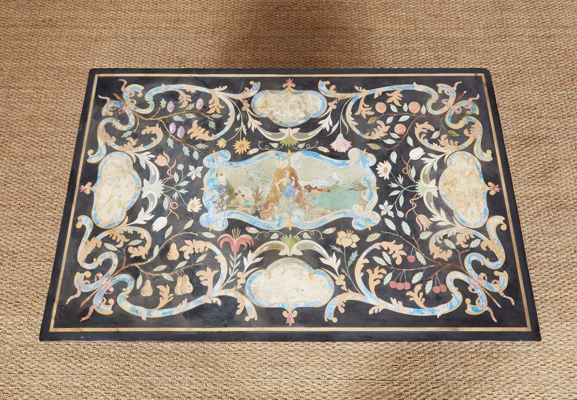 A coffee table with a fine 19th century Italian, probably Florentine, scagliola top, depicting a central polychrome image of Pan in a bucolic riparian setting, entwined with flowering branches, including cherries, with marbled shapes at the compass