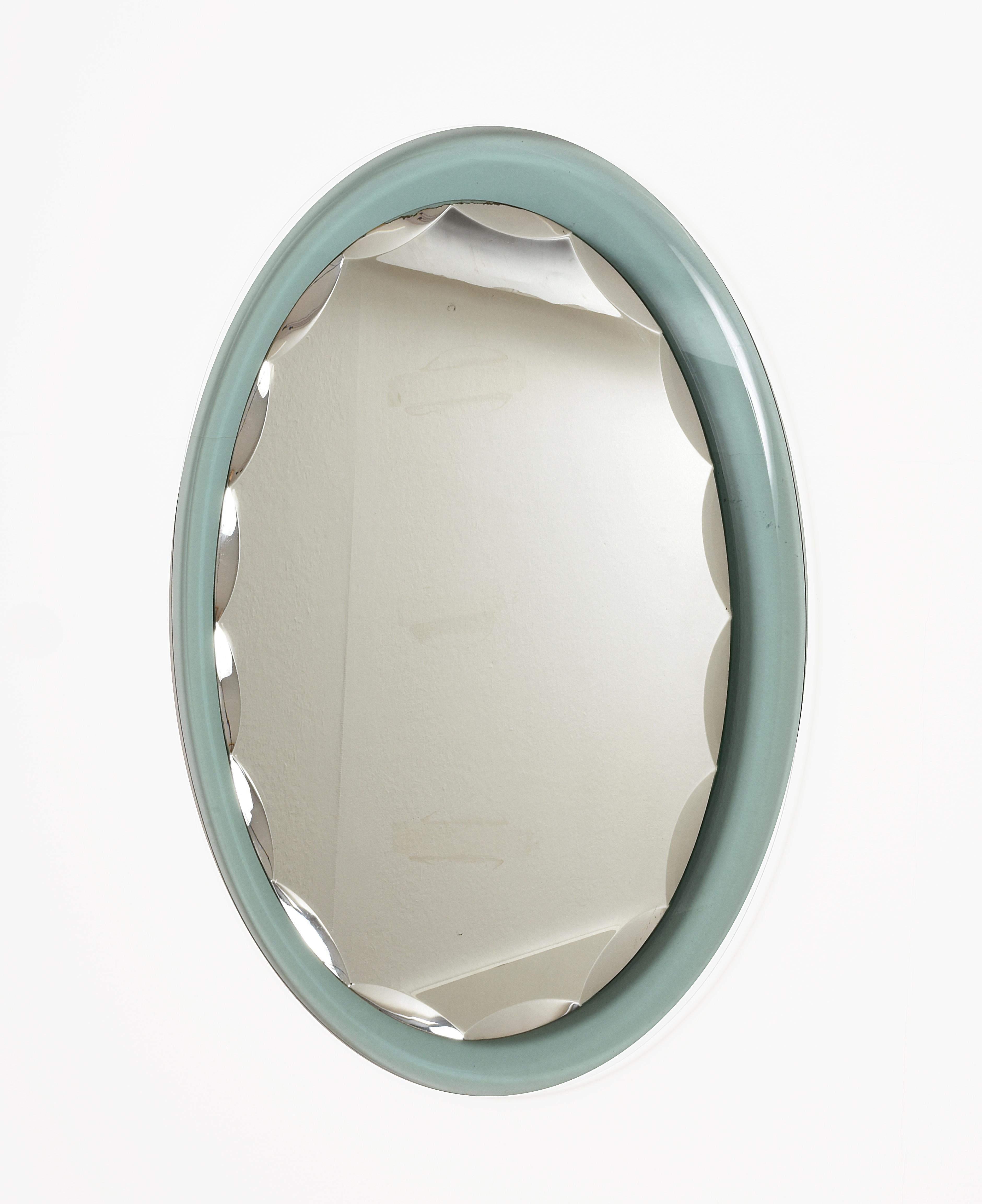 Beautiful mirror with light green frame and bevelled oval mirror.
This Italian Scalloped Mirror in the Style of Fontana Arte, Italy, 1960 is no longer available.
Mirror by Italian maker crystal Art. Green glass frame with decorative bevels on the