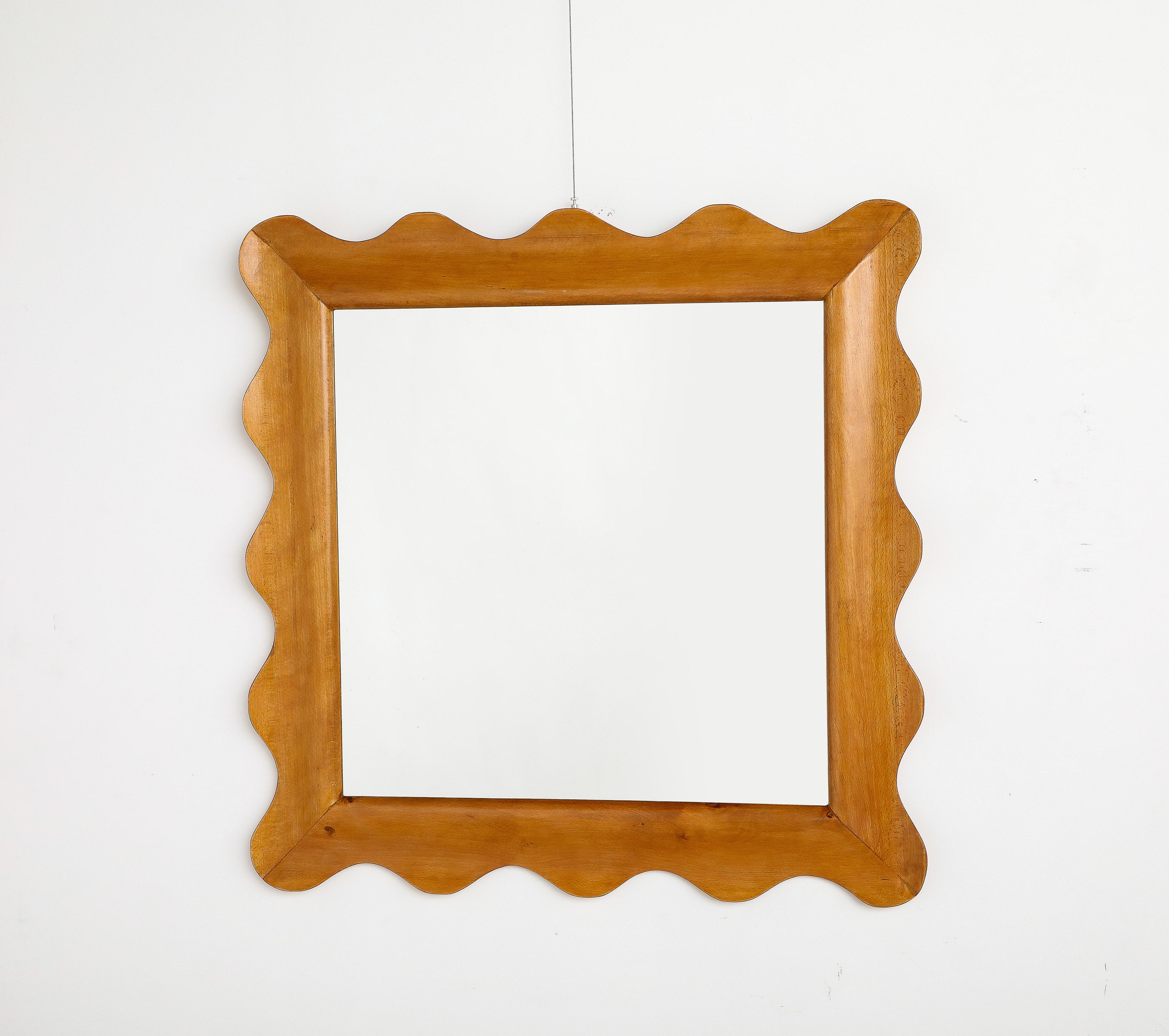A charming scalloped shaped carved oak square wall mirror.  Of whimsical and wonderful form; the wood is warm and organic. 
Italy, circa 2020 (made with old wood panels). 
Size: 35 1/2