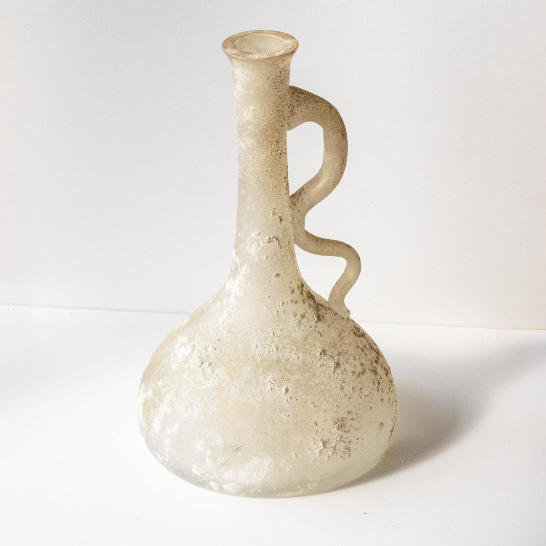 Vintage Italian Scavo style vase made of frosted white glass from Murano, Italy. Unique wavy handle and bulbous base.