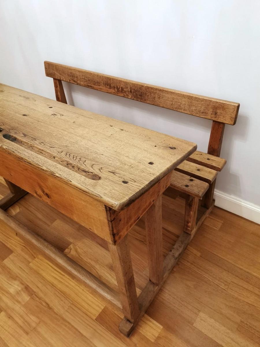 Italian school desk in solid oak, the bench is at one with the desk, there are housings for ink bottles and those for pens, under the desk, there is a housing for books and notebooks, between the legs there is a small beam that functioned as a