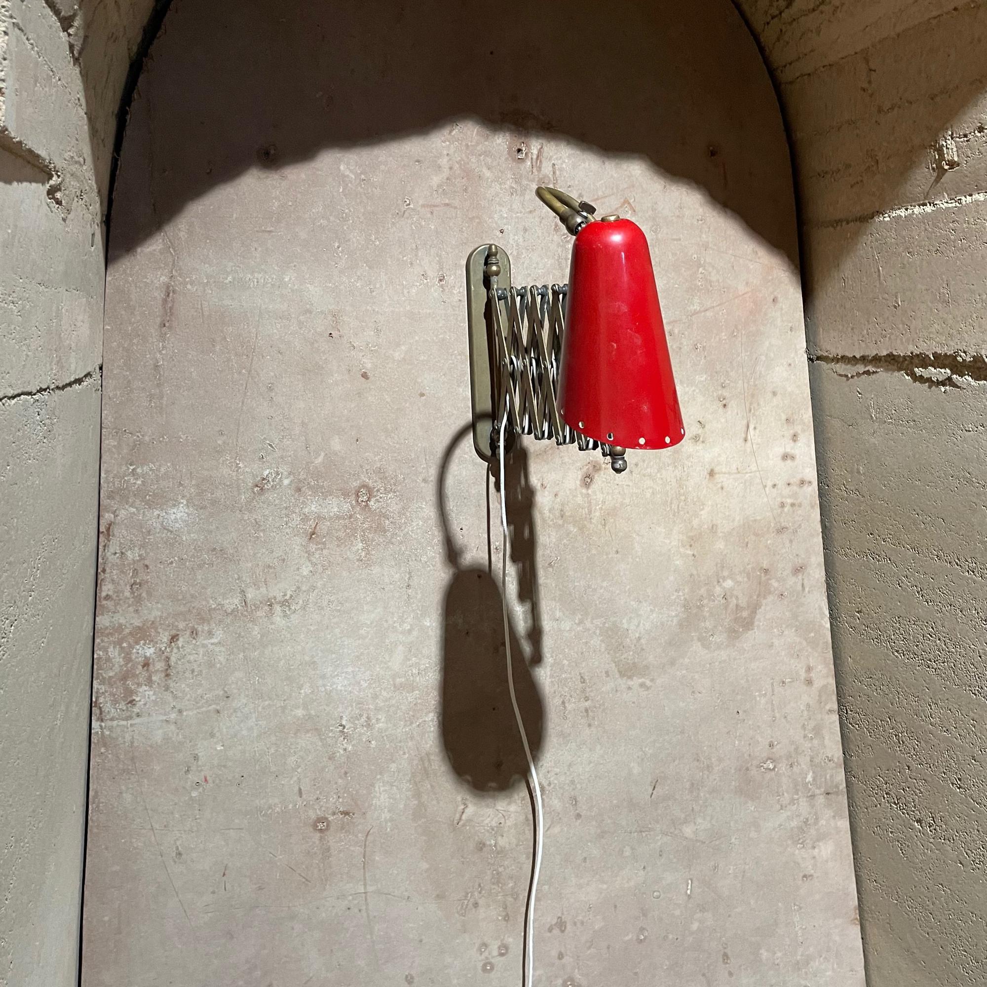 Italian Brass Red Scissor Wall Lamp Sconce ITALY 1950s
Red perforated cone shade. Unmarked. In the style of Stilnovo.
31 fully extended, 16 closed 11 h x 4.5 wide inches
Original Unrestored Vintage Preowned Condition.
Patina consistent with age and