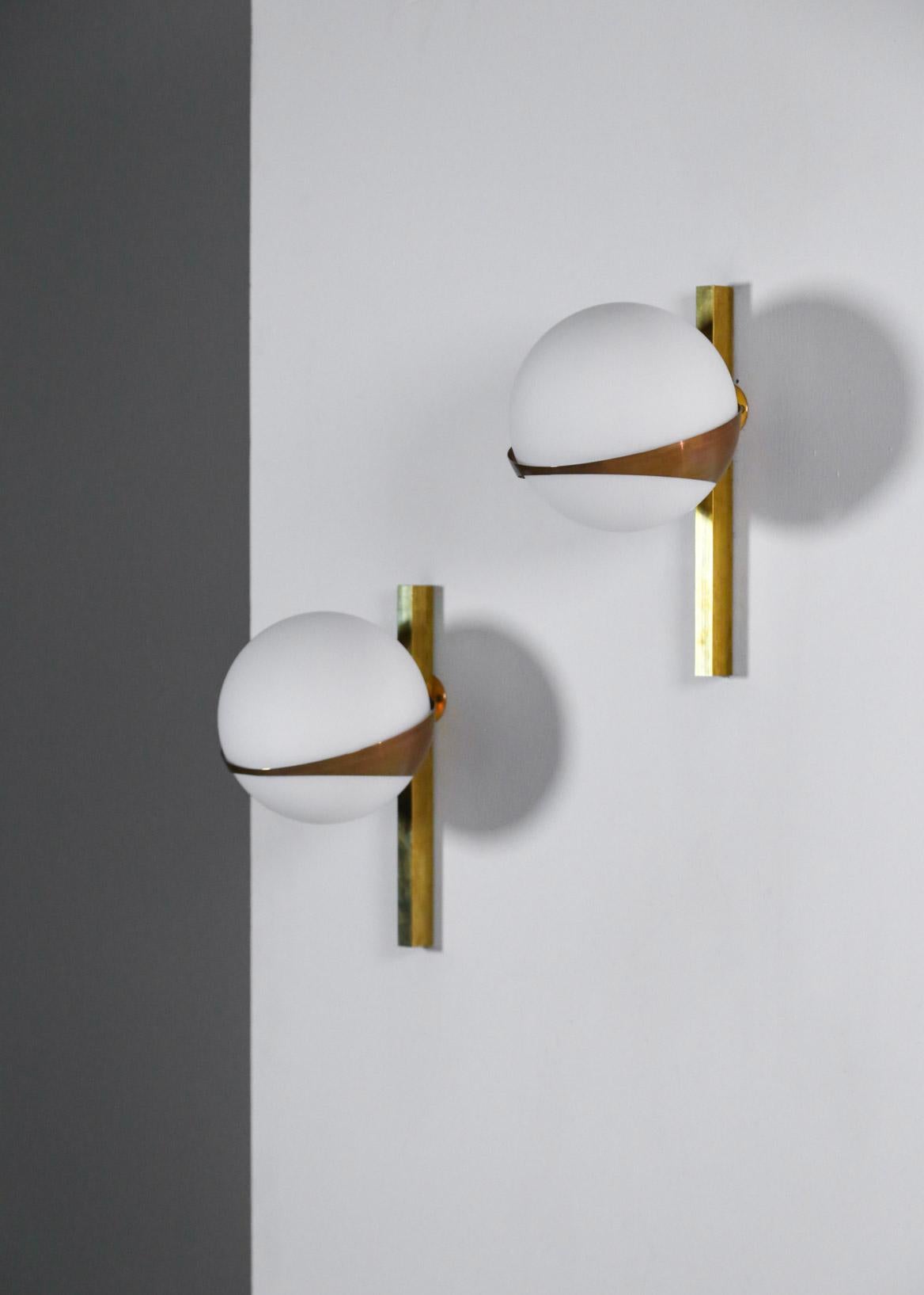 Modern Italian sconces made of brass and opaline.
Beautiful sculptural and decorative wall light in the style of Stilnovo.

 