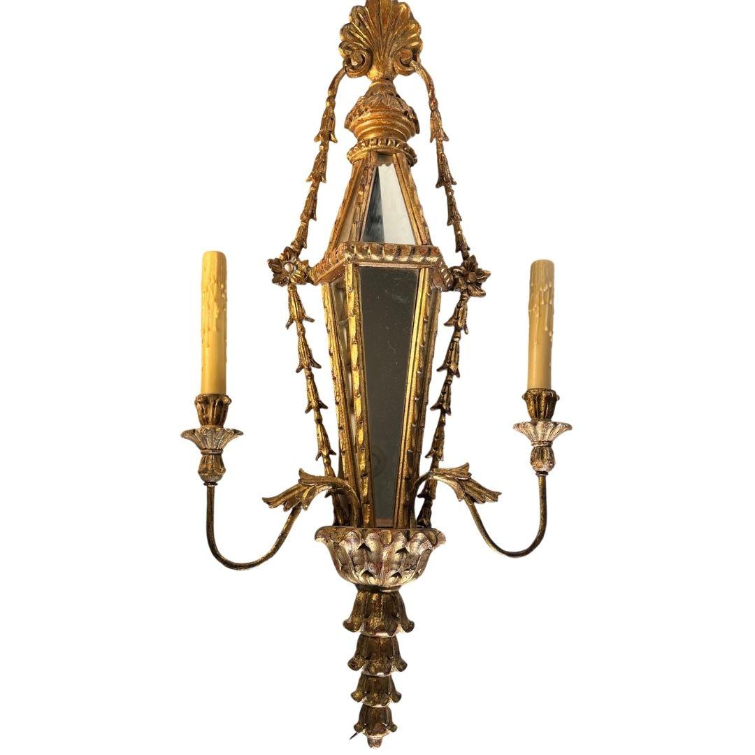 A pair of gilded wooden sconces with mirror from Italy. Circa mid 29th century. 

