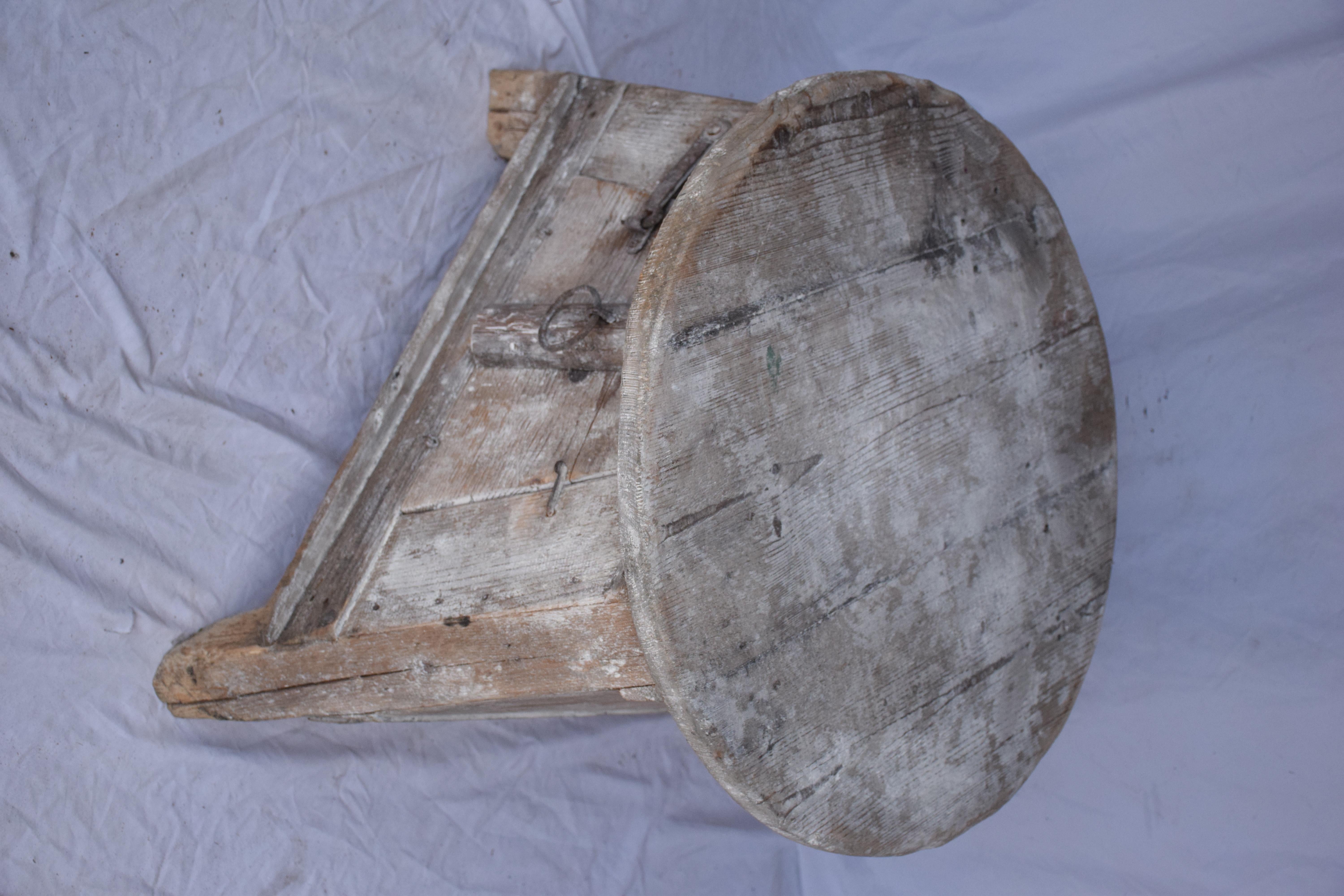 Italian sculptor's stand with round top. Flared triangular base with a side door for storage. Remnants of old paint and plaster present. Such a fun unexpected side table.
