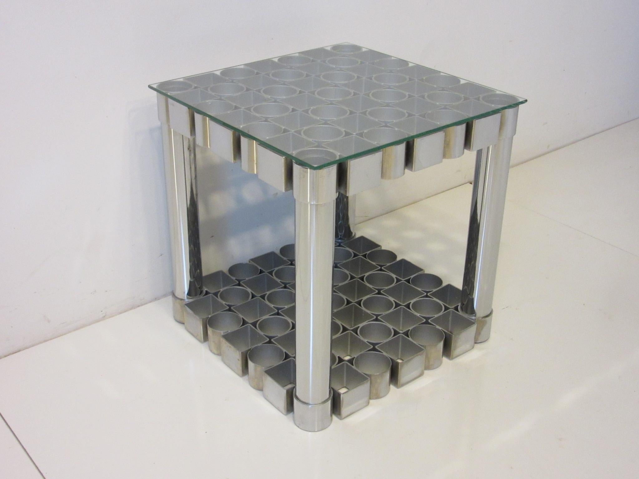 A handcrafted 1970's sculptural chromed steel side table with square and circle designs , this Op Art styled piece has all hand welded construction . This heavy well made occasional side table has a glass top and still retains the manufactures label