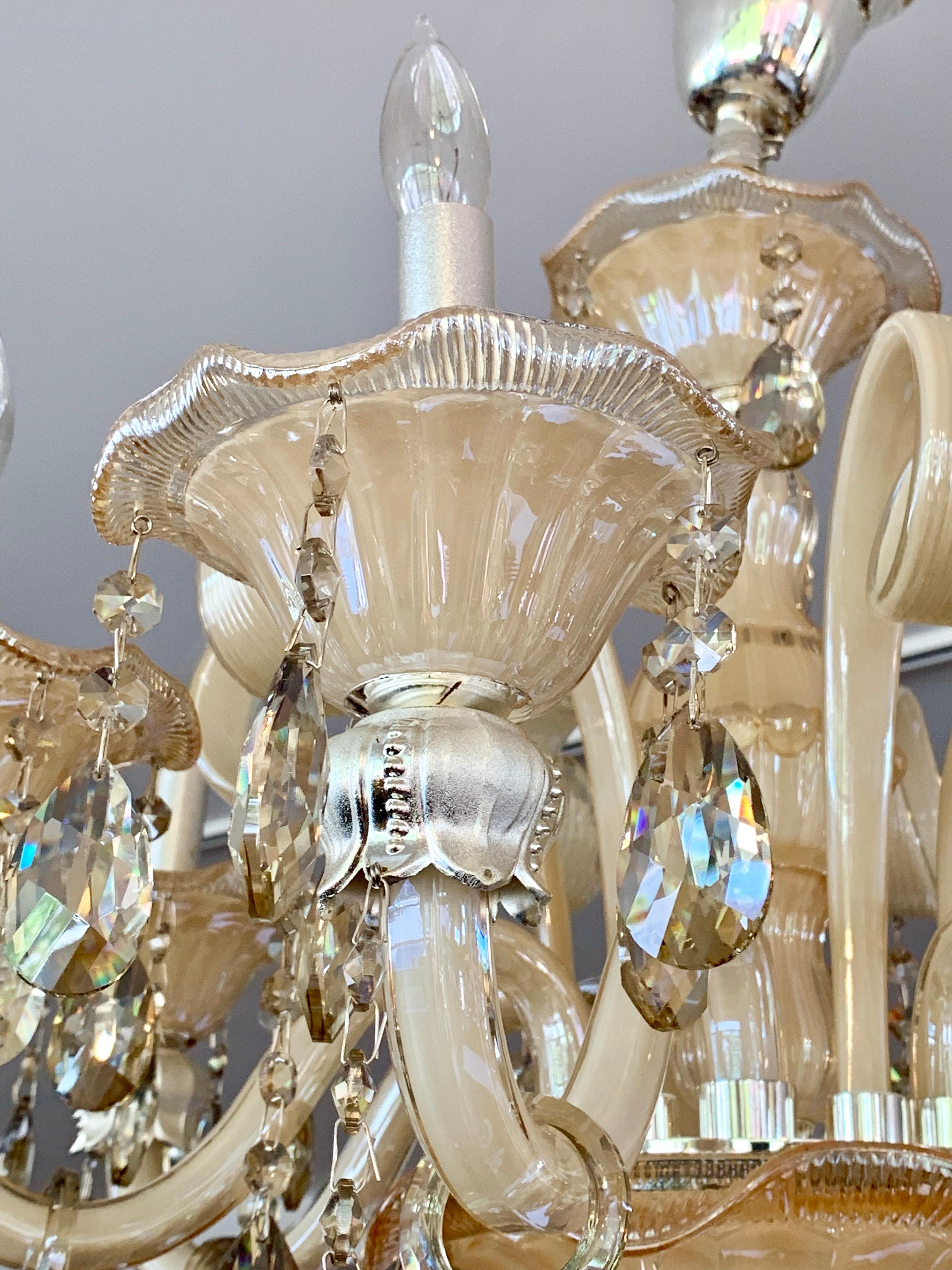 Stunning six arm Italian Murano glass Mid-Century Modern chandelier done in a vanilla colored glass. There are crystals that adorn the piece and incredible detail throughout. It is wired for USA and the chair can be extended if needed.
  