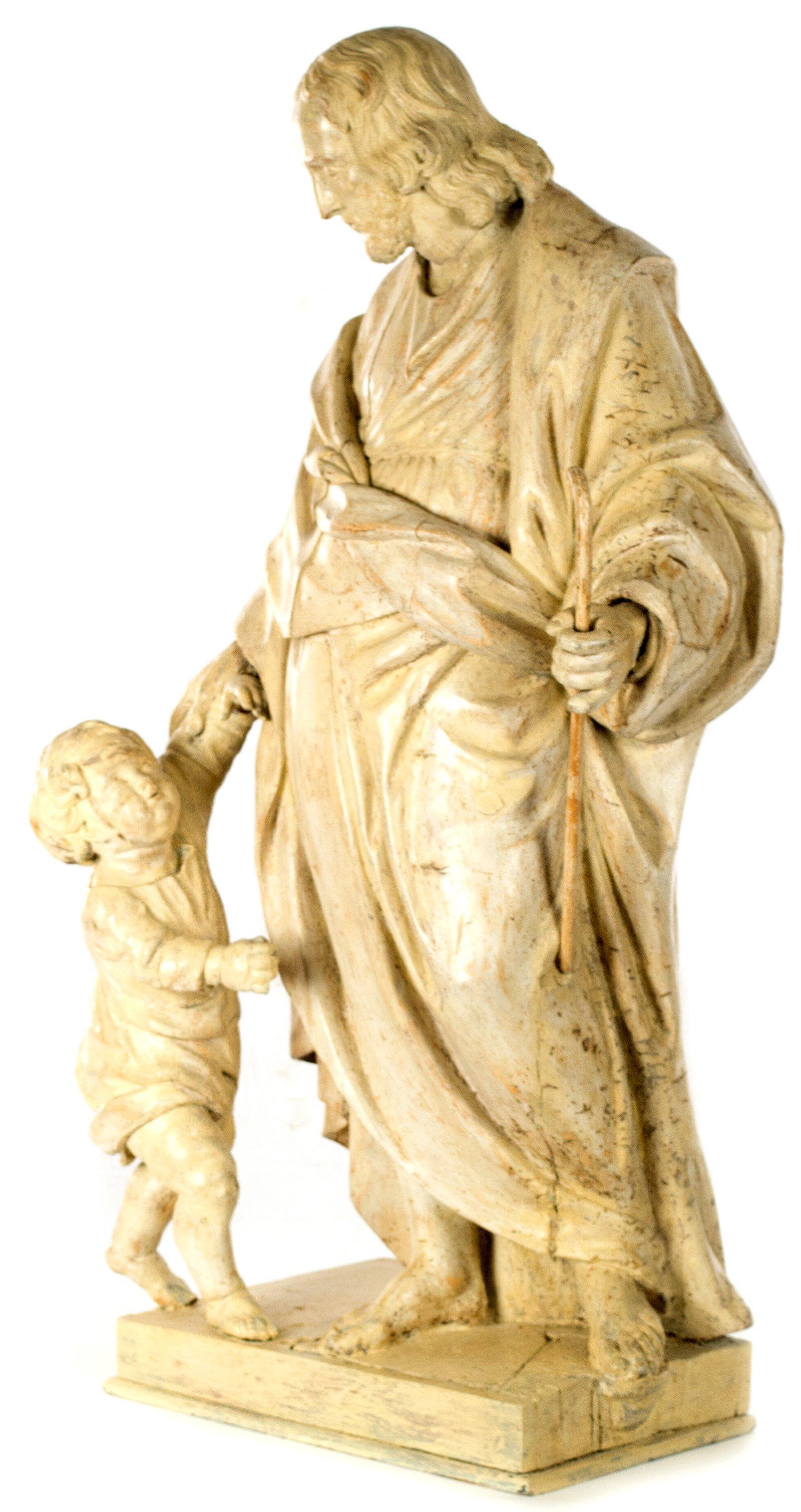 Holding a shepherd's crook in his left hand and comforting a child with his right, this 19th century Italian statue depicts Christ as the good shepherd. The work is beautifully sculpted, using traditional techniques and materials dating from