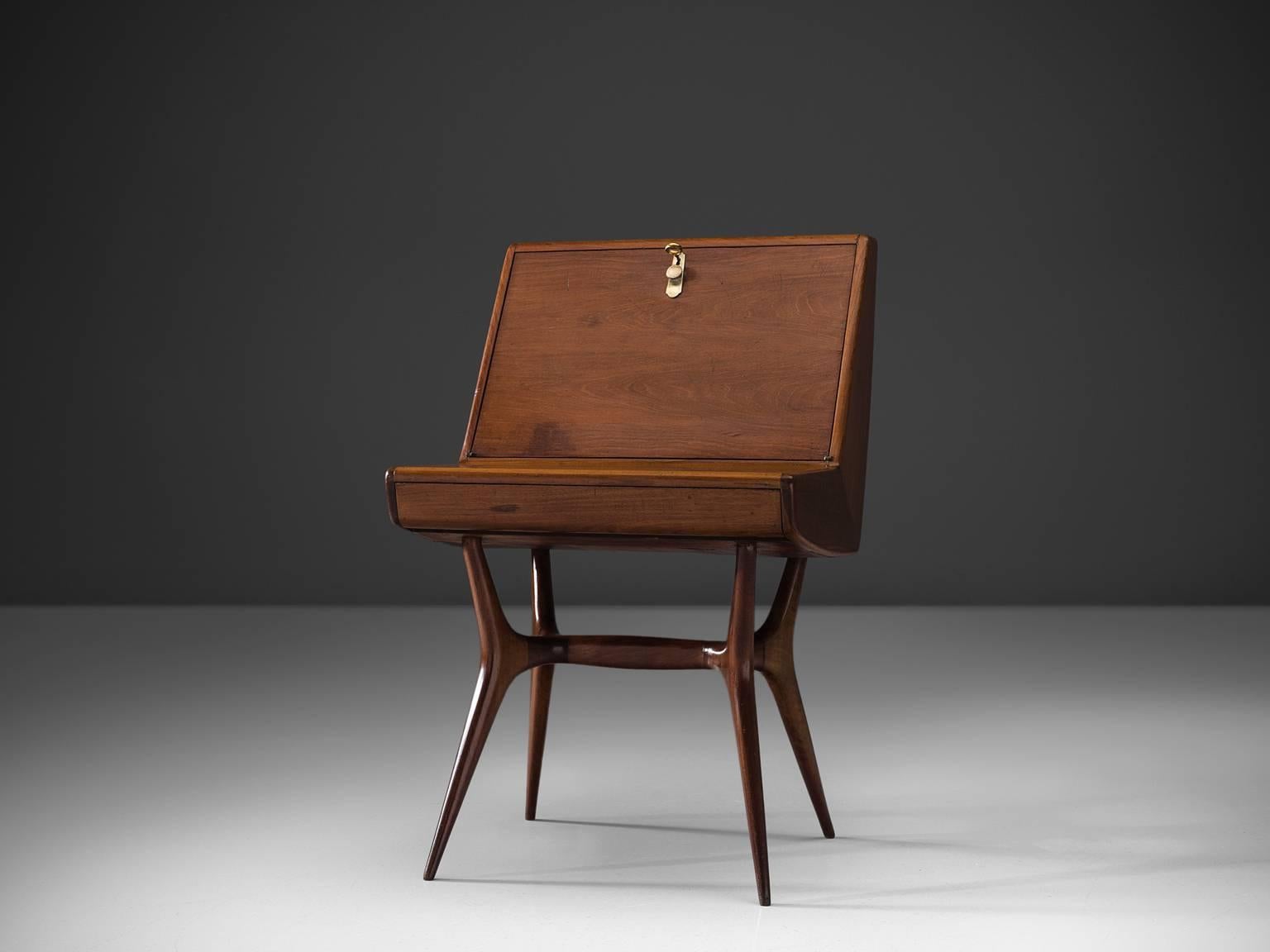 Writing table, teak and brass, Italy, 1950s

Beautifully and elegantly shaped Italian secretary in wood. The legs are unmistakably Italian and are angled outwards which give this piece a firm appearance. The proportions of this small secretary are