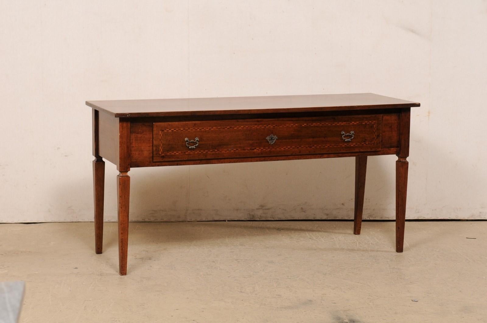 An Italian bench-made wooden console table with drawer from the mid-20th century. This midcentury table from Italy is approximately 5.25 feet in length, with rectangular top over a deep-set apron that houses a single large drawer (fitted with a pair