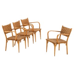 Set italiano di quattro poltrone in paglia intrecciata e legno biondo