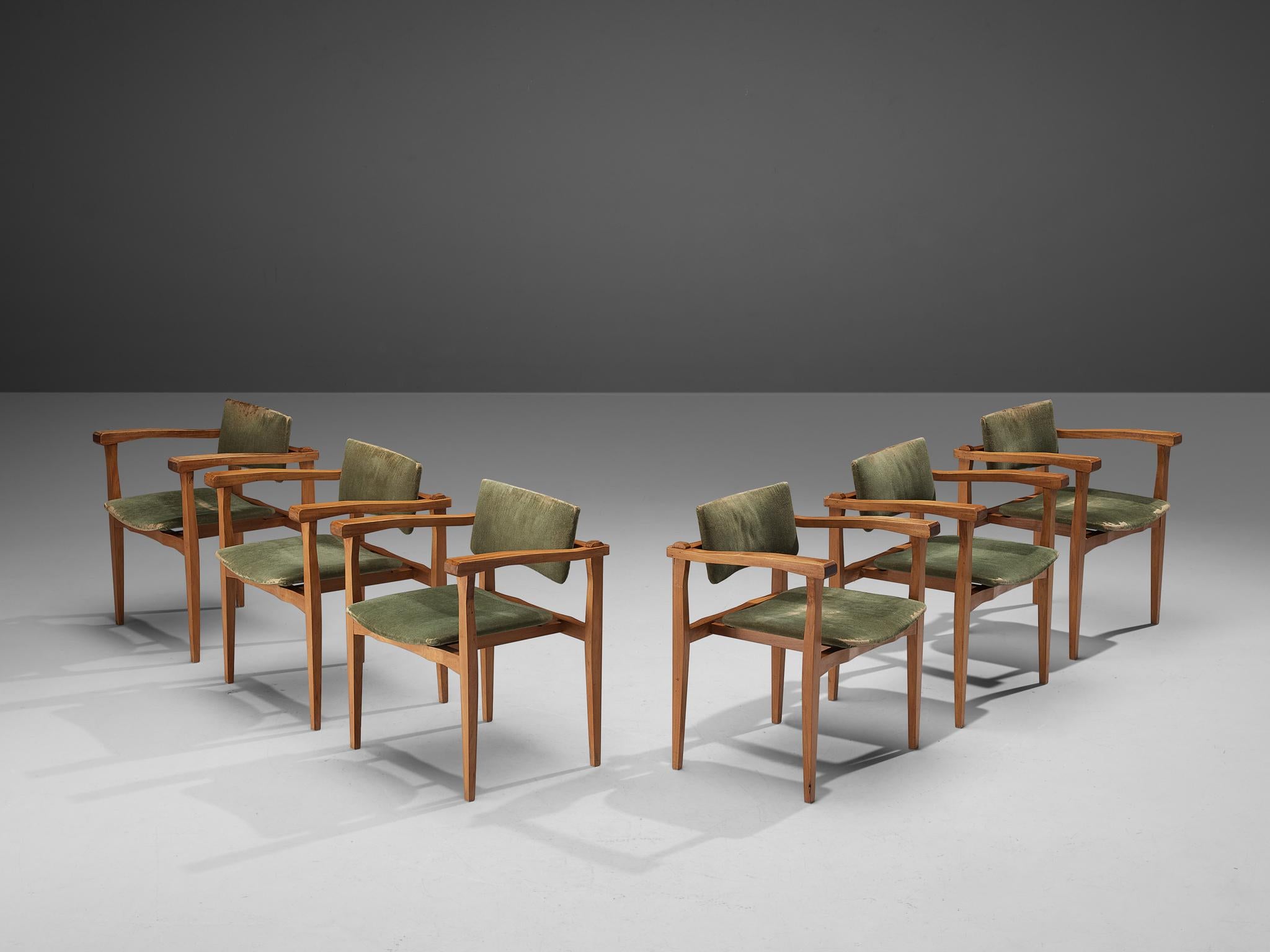 Set of six armchairs, walnut, velvet, Italy, 1960s.

This set of six armchairs made in Italy is modest and pure in its design. The chairs feature an open and architectural walnut wooden frame, build up from horizontal and vertical lines. The
