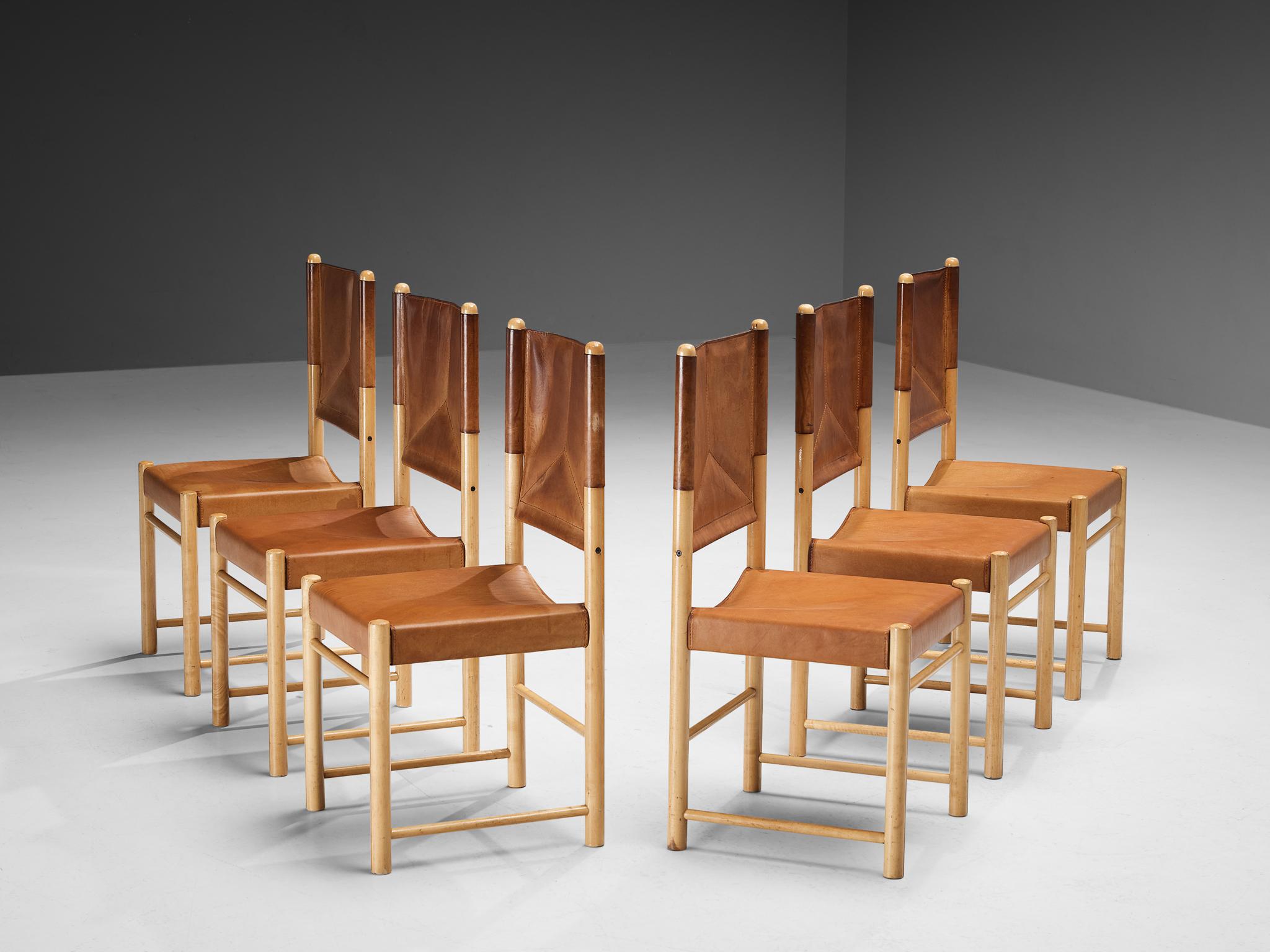 Set of six dining chairs, beech, leather, Italy, 1970s.

A delicate set of chairs that are well-proportioned and will elevate one's dining area in a vigorous and strong way. The wooden frame is composed of cylindrical beams to which the leather is