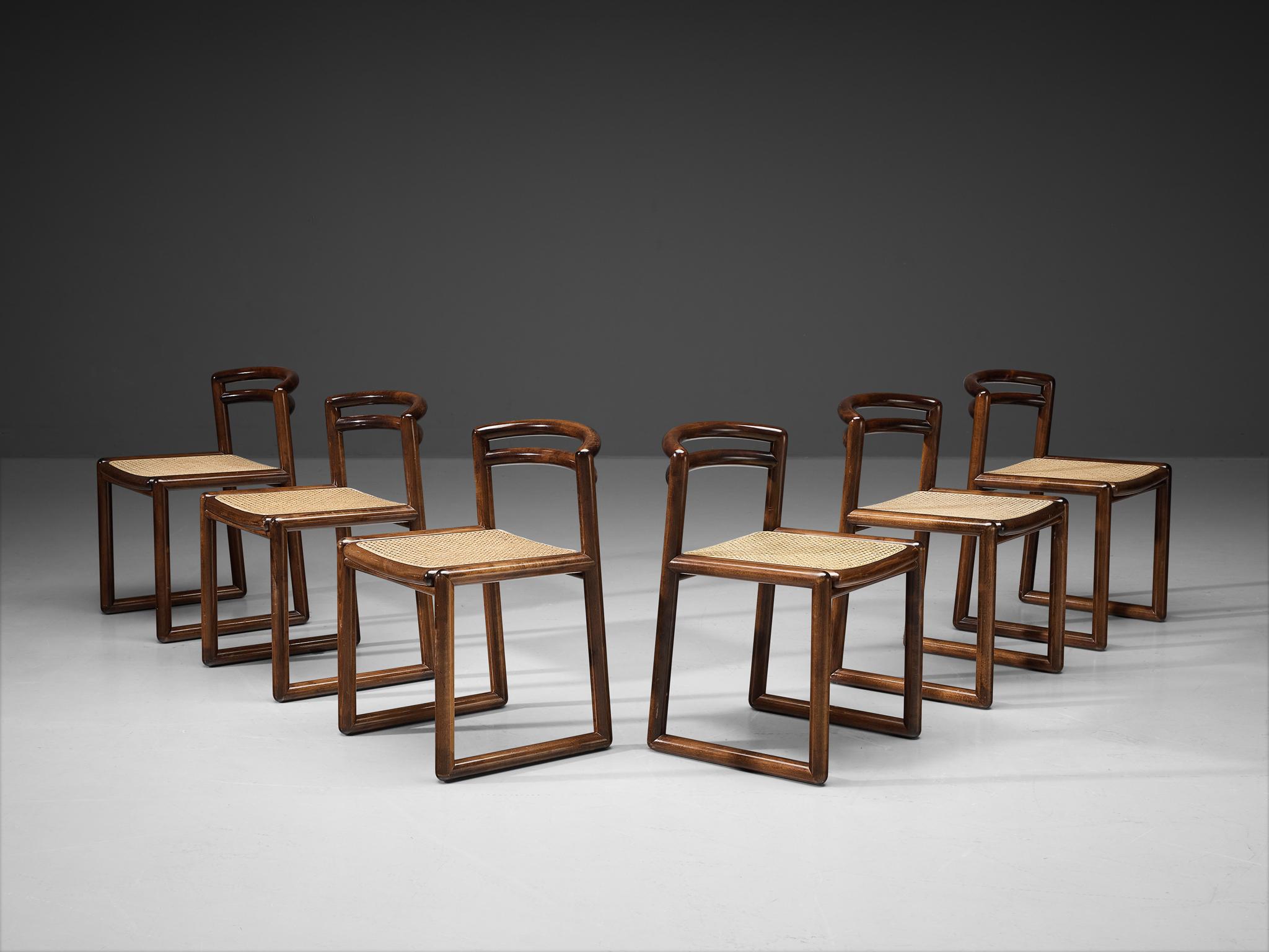 Set of six dining chairs, stained beech, cane, Italy, 1970s. 

Set of six quirky italian dining chairs. These chairs feature a dark stained wooden frame with a modest gloss finish that brings out the grain pattern in an elegant manner. The