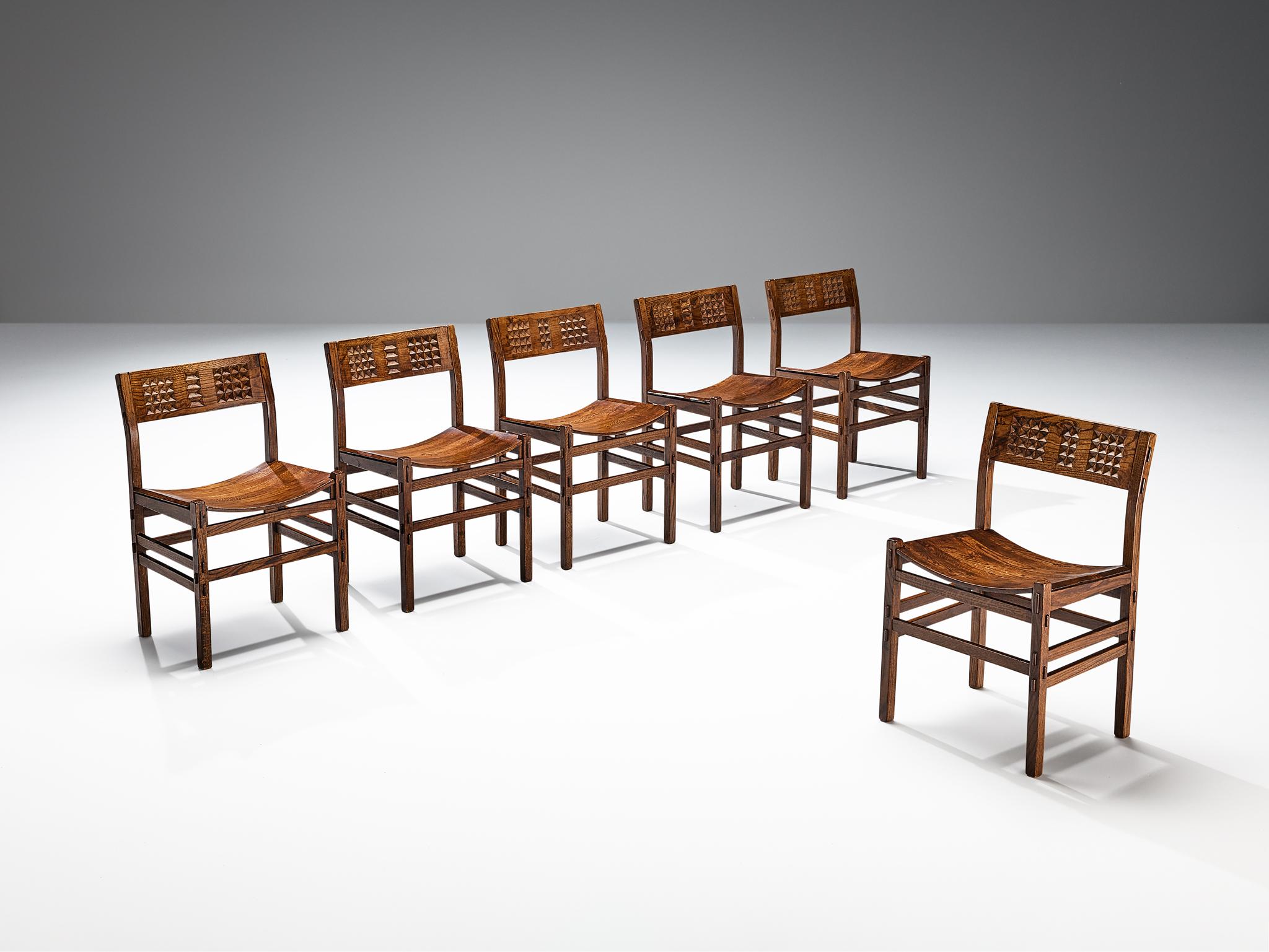 Set of six dining chairs, stained oak, Italy, 1970s.

Beautiful set of oak chairs with geometrical carved details in the backrests. The sides and backs of the frames of the chairs have multiple thin slats for support and stability in the design. The