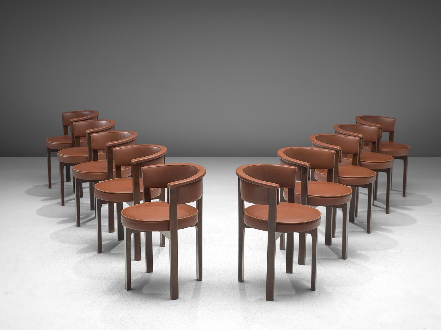 Set of 10 chairs, faux cognac leather, darkened beech, The Netherlands, 1960s.

This set of ten armchairs is executed in darkened wood and a red-brown leatherette upholstery. This is a comfortable design with simplistic, strong lines and balanced