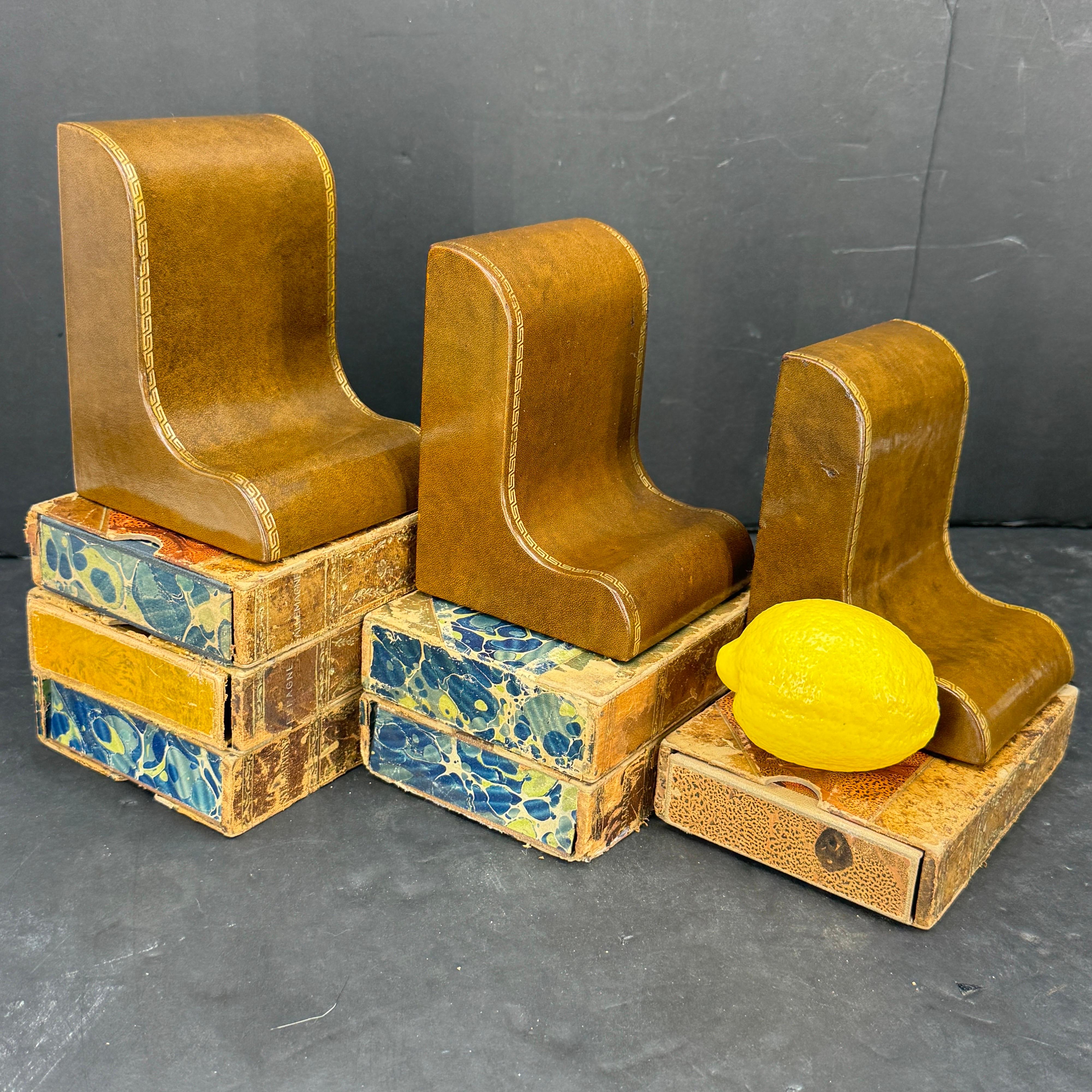 We are offering 3 Classic Mid-Century Leather Bookends. These handcrafted bookends with Greek Key gold embossing would certainly accentuate your home on a bookcase, table, or desk. 
Please note that each of the 3 bookends are priced individually and