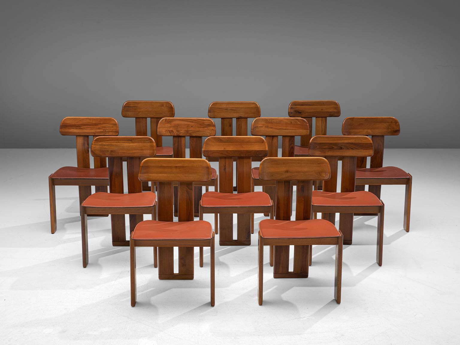 Sapporo for Mobil Girgi, set of 12 dining chairs, Italian walnut and red leather, Italy, 1970s.

Set of sculptural chairs that feature wonderful backrests, consisting of two vertical slats distanced from each other. At the bottom and top these are