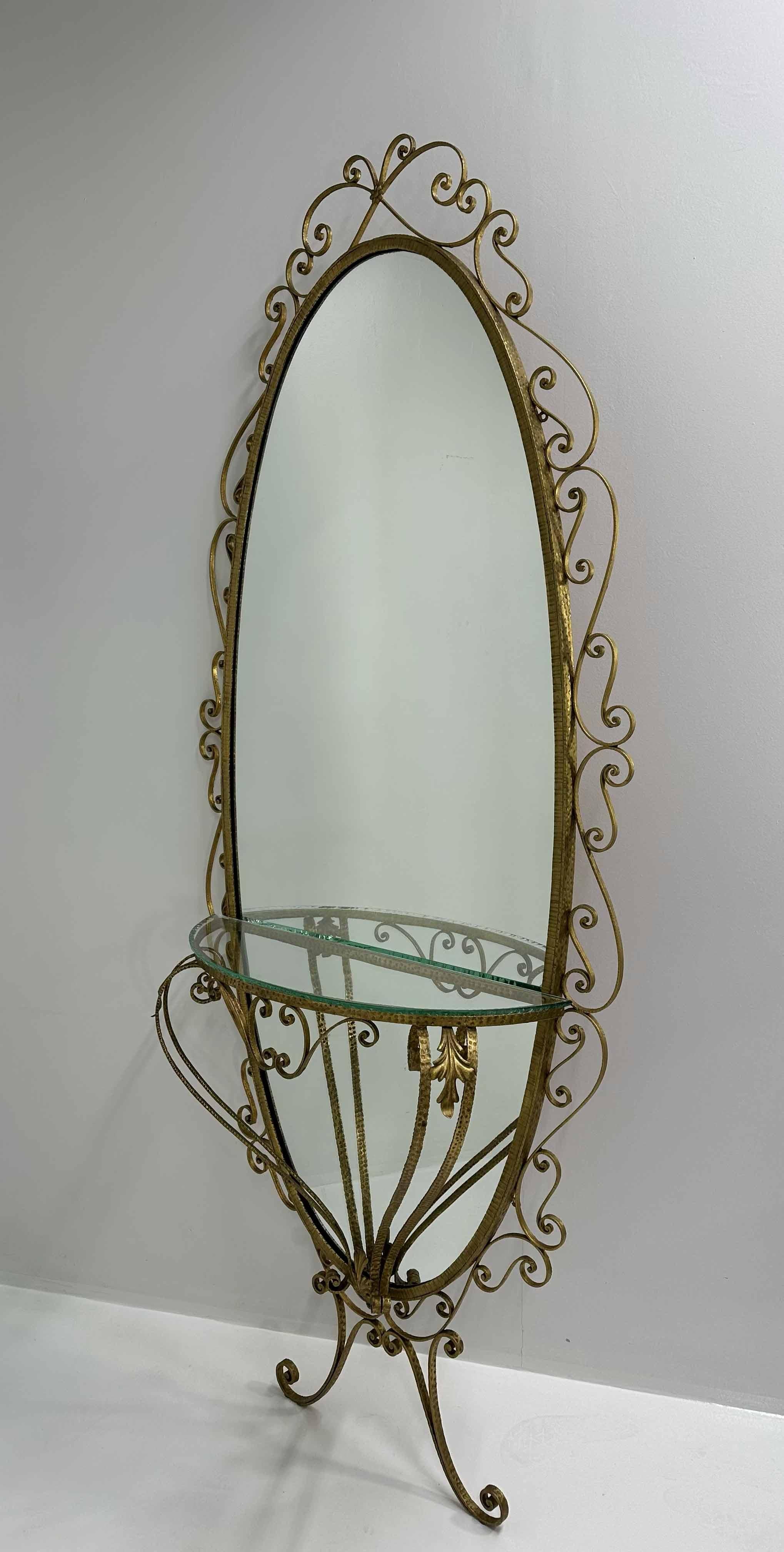 This set is composed by a Wall Mirror console table and a pouf and it was produced in Italy, more precisely in Turin (City in the north of Italy) around 1960s and it was designed by Pierluigi Colli. 
The full size floor mirror is made of an hand