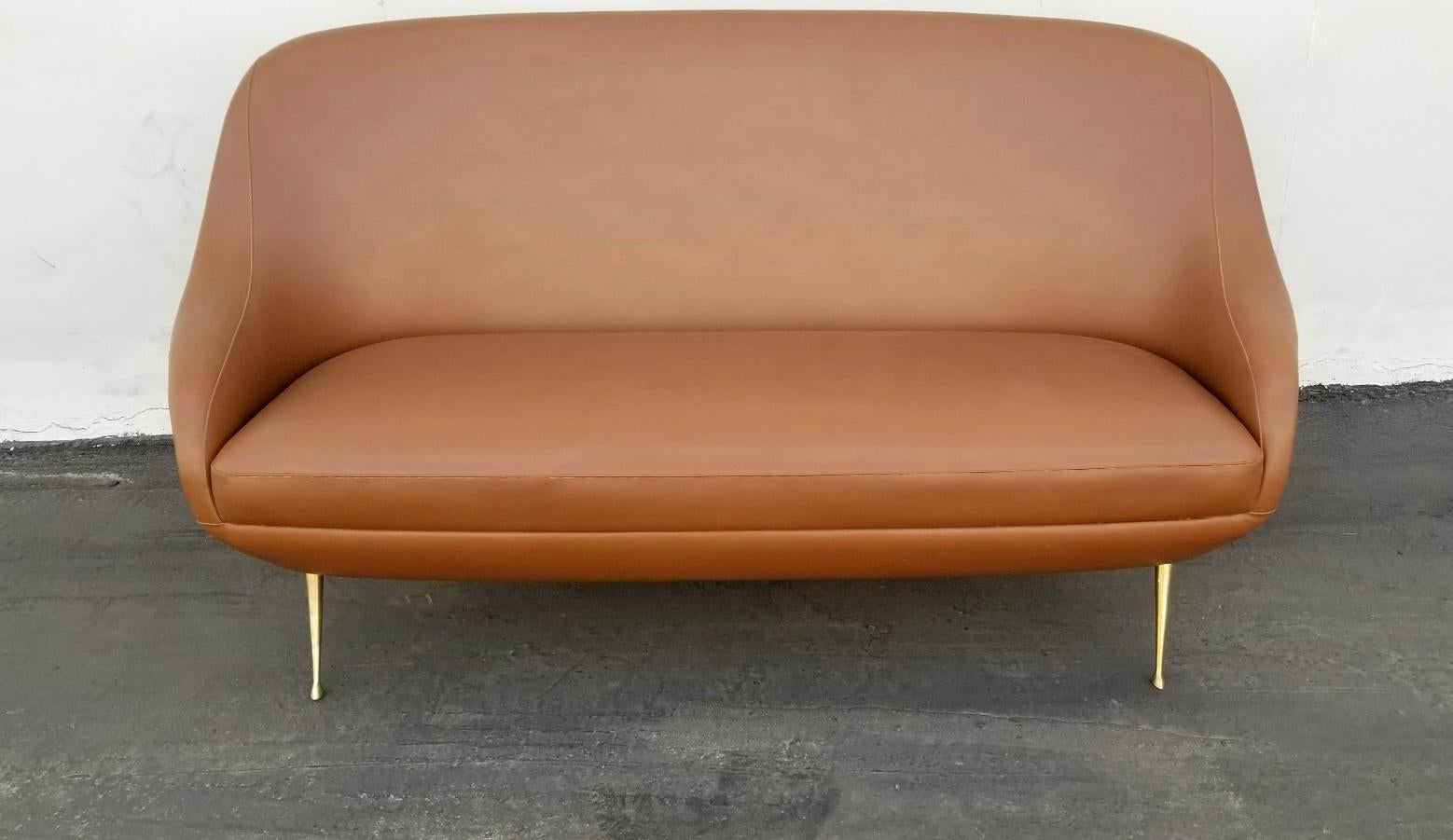 Italian  Isa Bergamo mid century settee original faux leather upholstery and original mid century condition. Brass legs. 
