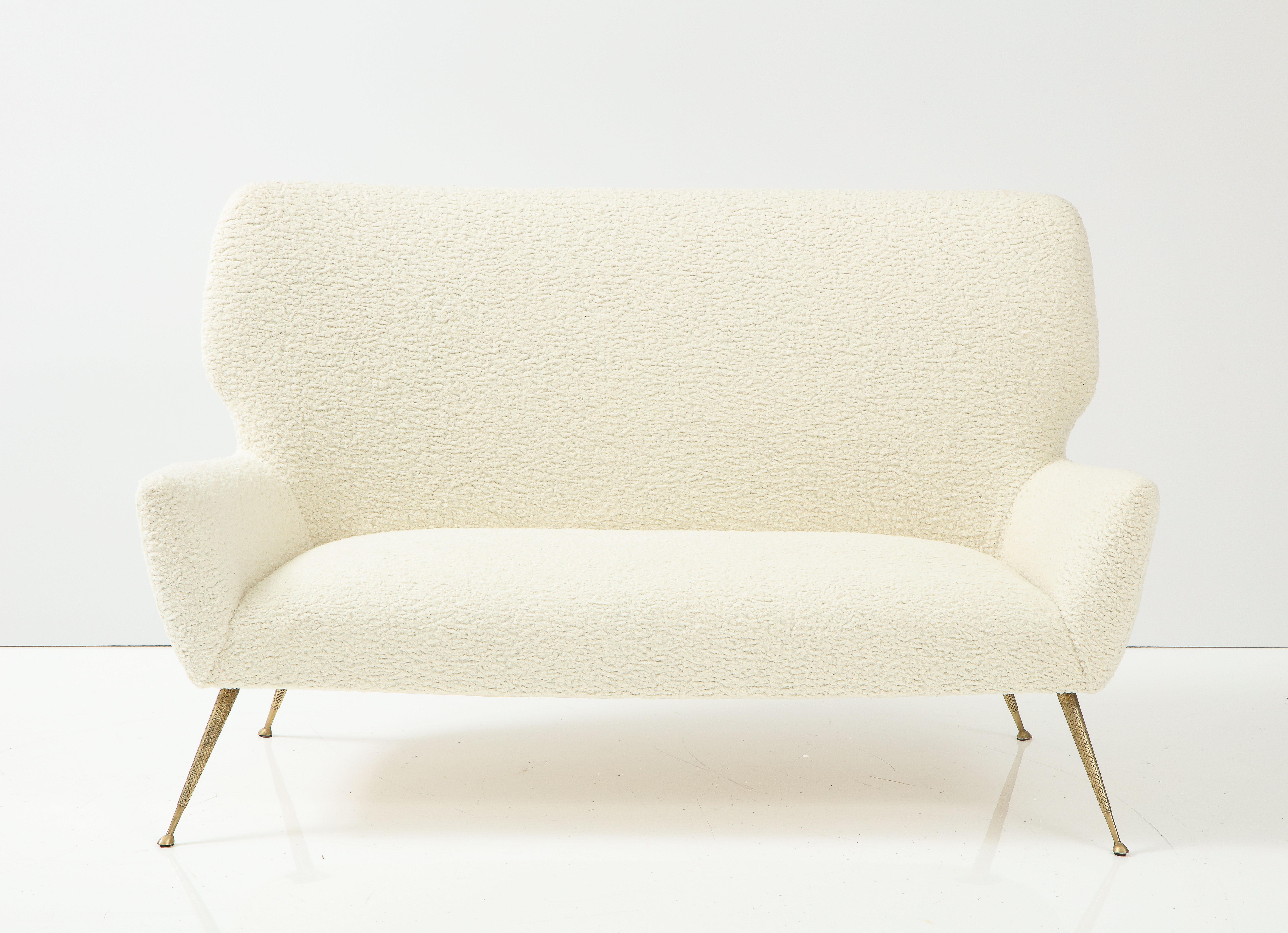 Italian Settee with brass legs, Attributed to Gio Ponti for Casa e Giardino.
A rare and unique settee with curved, elegantly shaped back and arms supported on splayed and tapered cast brass legs with a cross hatch design. Extremely elegant with the