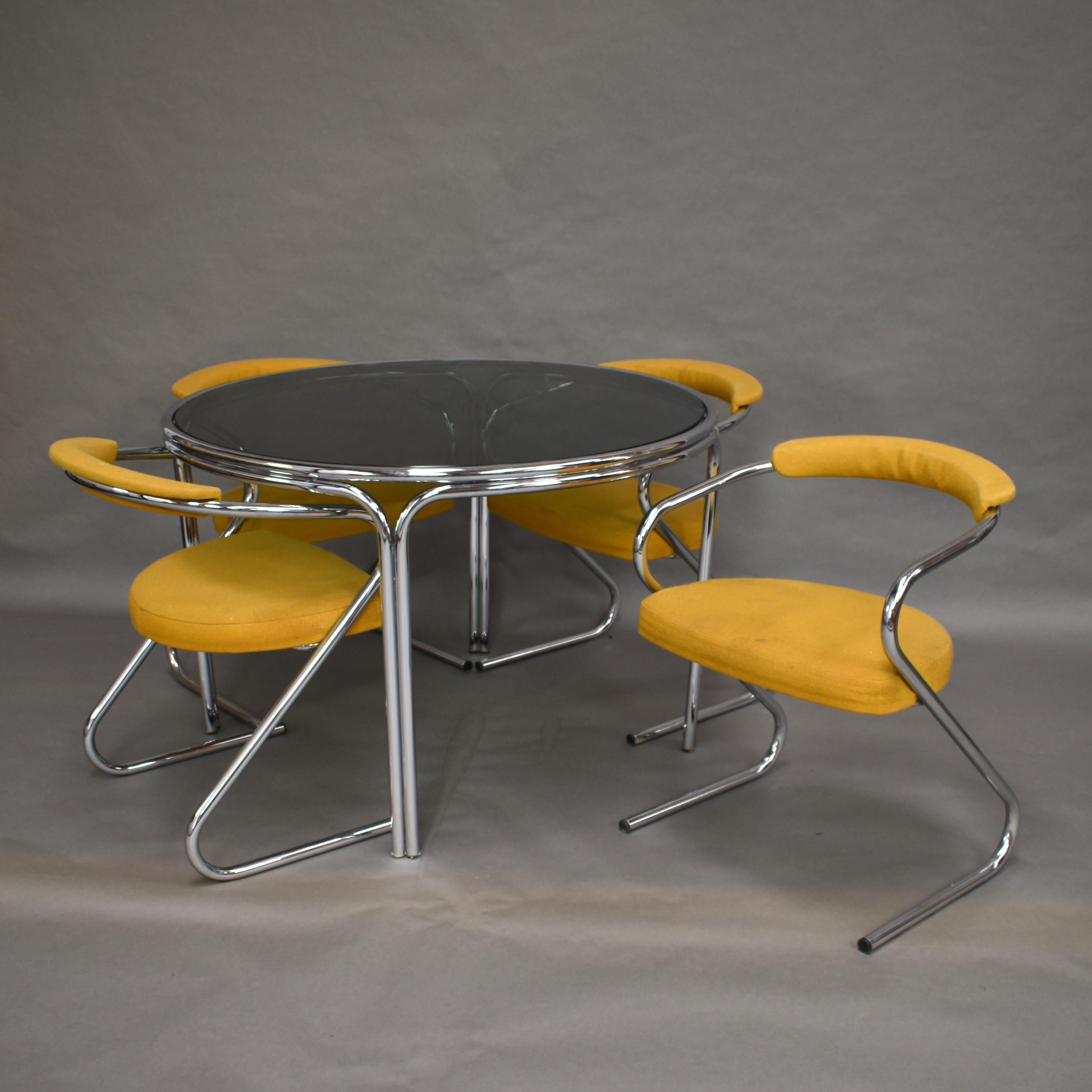 Very cool Italian dining set in chrome and smoked glass from the 1970s.

Designer: Unkown
Manufacturer: Unknown
Country: Italy
Date of design: circa 1970
Date of manufacture: circa 1970
Model: Dining table and four chairs
Material: chrome /