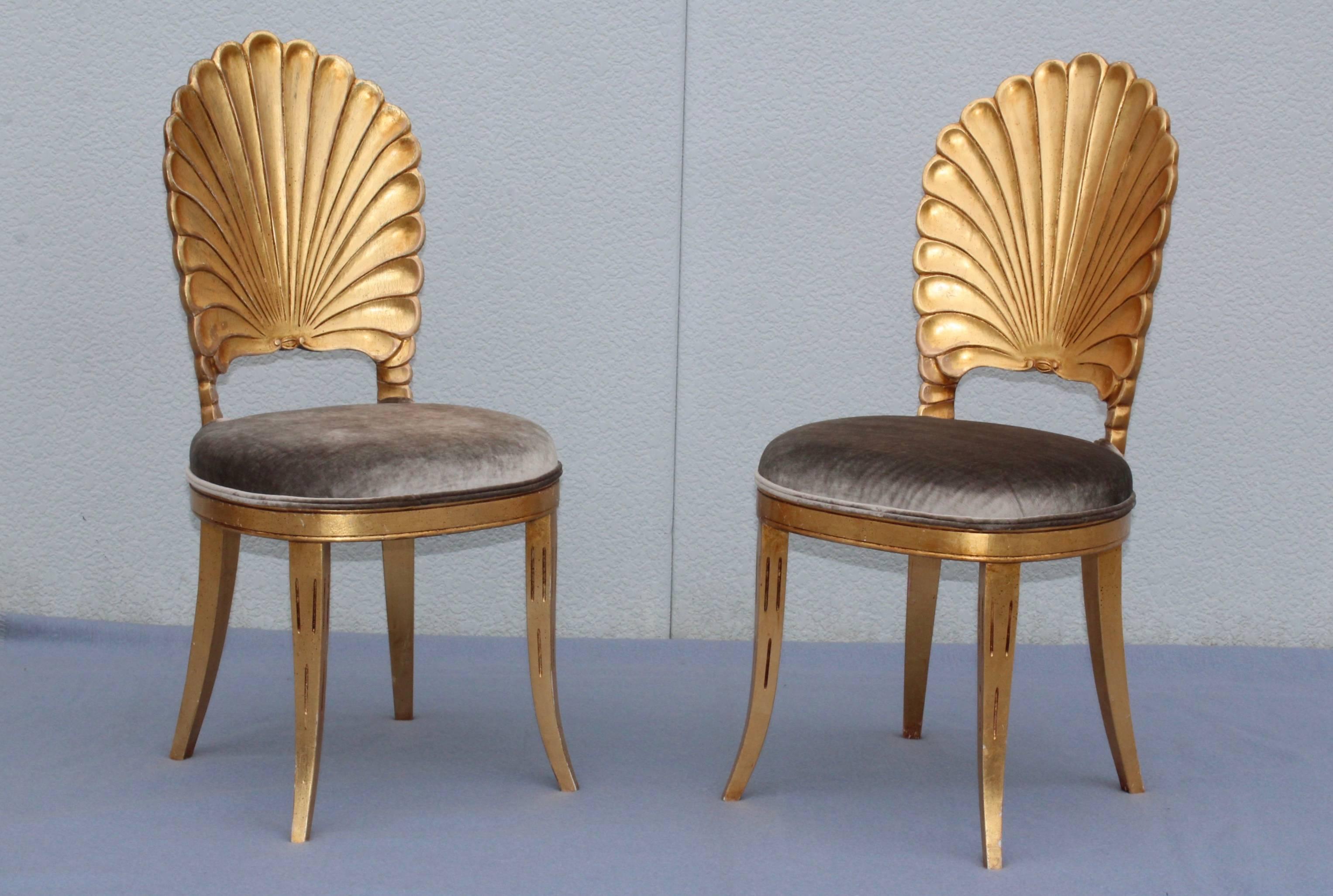 Stunning pair of 1950s Venetian Grotto carved shell back chairs, in vintage original condition with some wear and patina to the gold leaf finish. Newly upholstered in gray velvet.