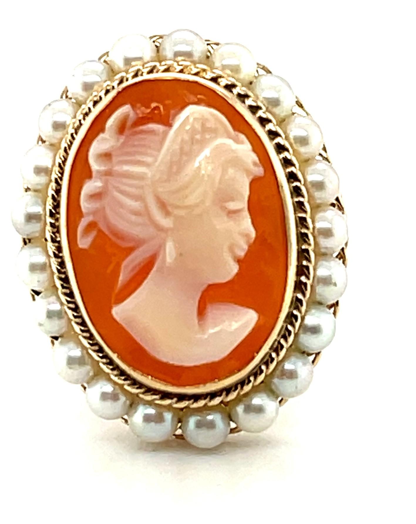 This pretty ring features a lovely shell cameo that was beautifully hand carved in Italy. The cameo is bezel set and encircled by 3mm seed pearls that have been hand-strung on fine gold wire. The pearls sit atop an intricate frame of hand-spun fine