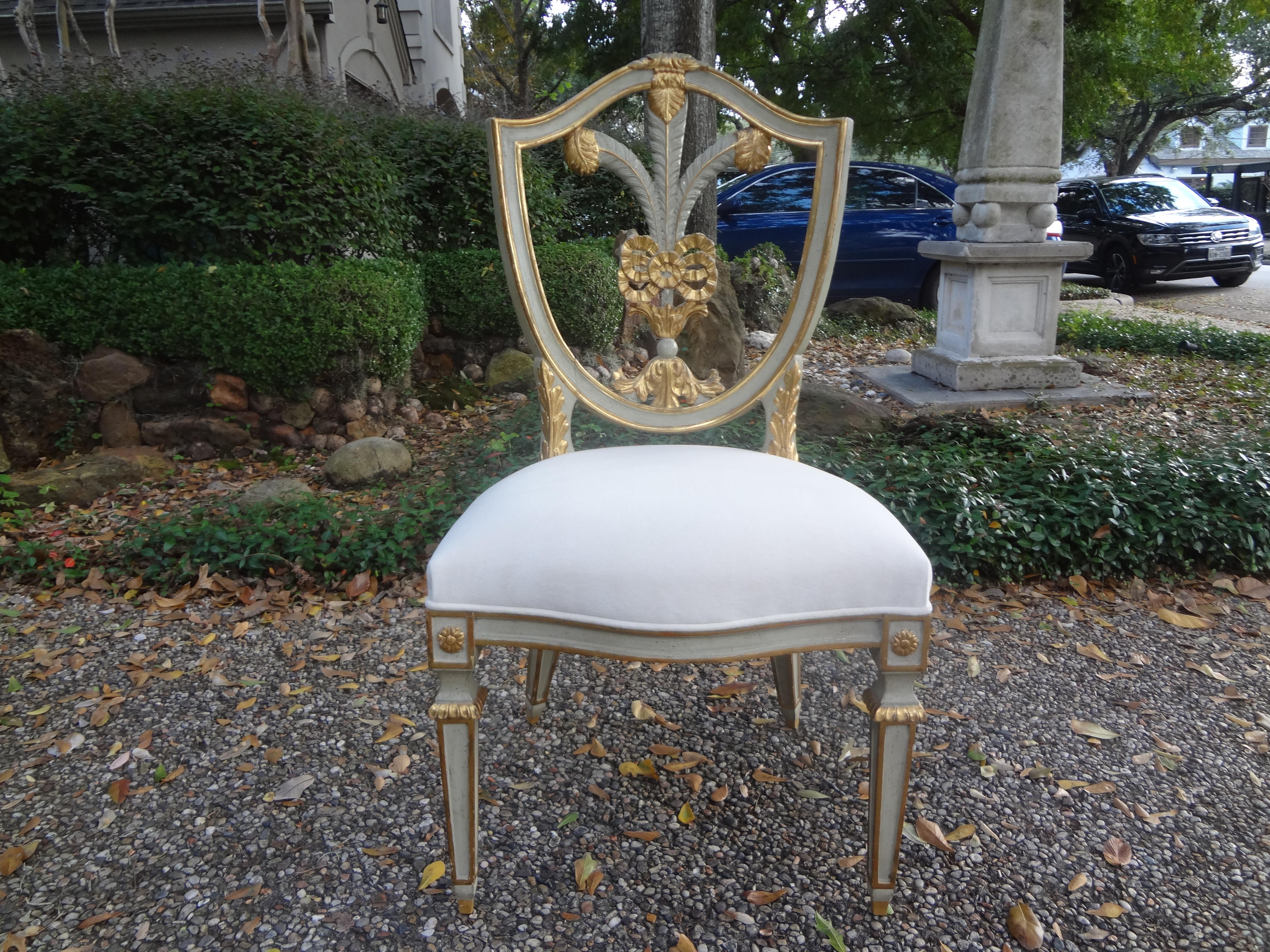 Italian Hollywood Regency painted and giltwood shield back plume chair. This stunning vintage Italian side chair or desk chair has fabulous Klismos style splayed legs. This midcentury chair was taken down to the frame and professionally upholstered