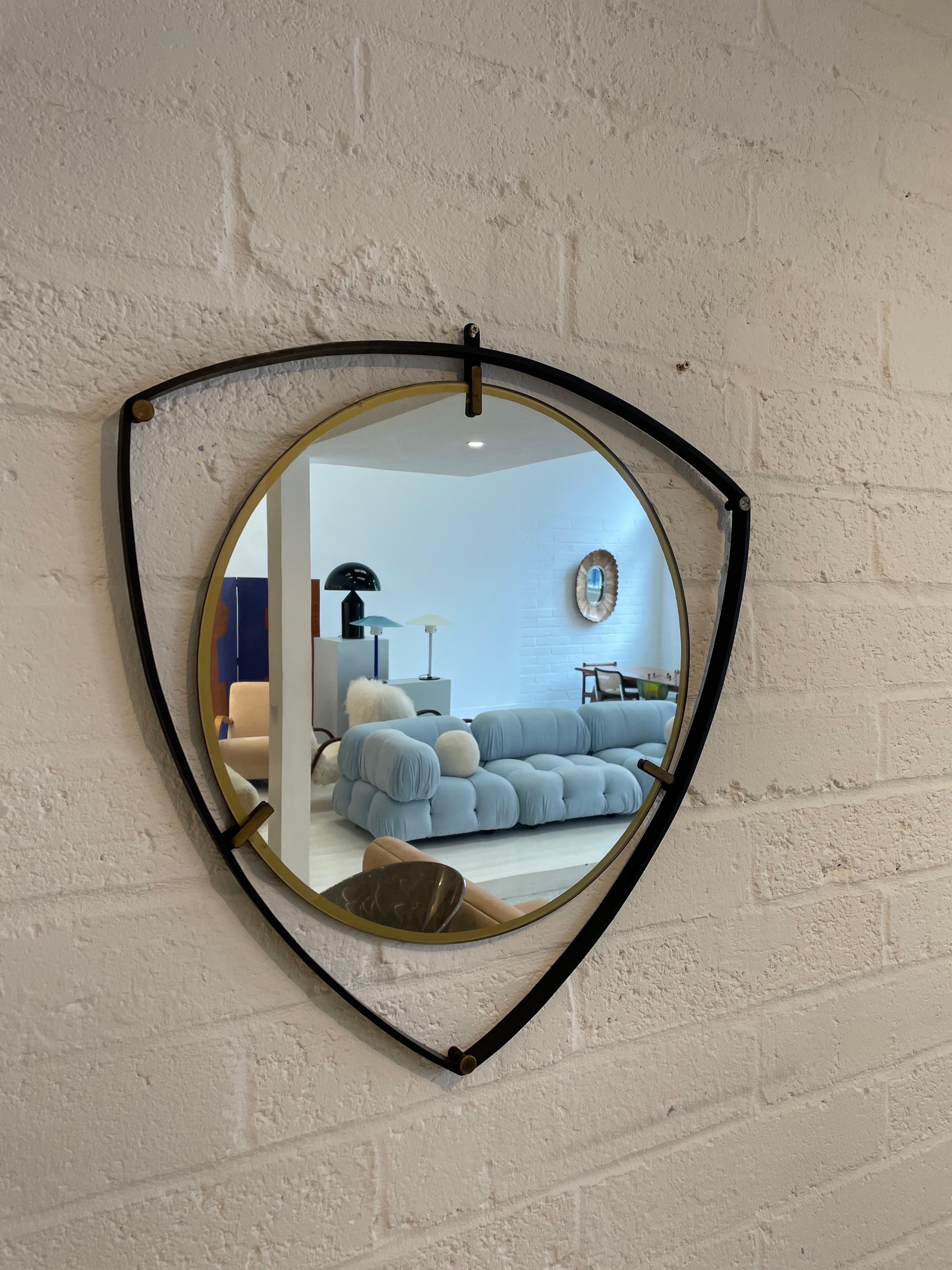 Height: 63cm
Width: 63cm
Depth: 2cm

Date: 1950s
Materials: Brass, Metal, Glass 

Description:The Italian shield wall mirror is a stylish and distinctive piece that draws inspiration from traditional Italian design elements. Resembling a shield in