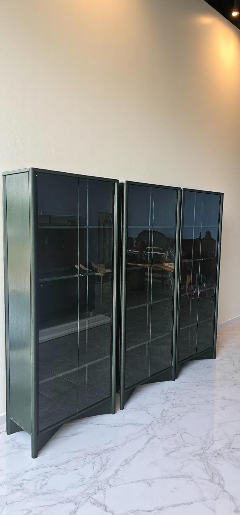 This magnificent set of three center display cabinets, model 