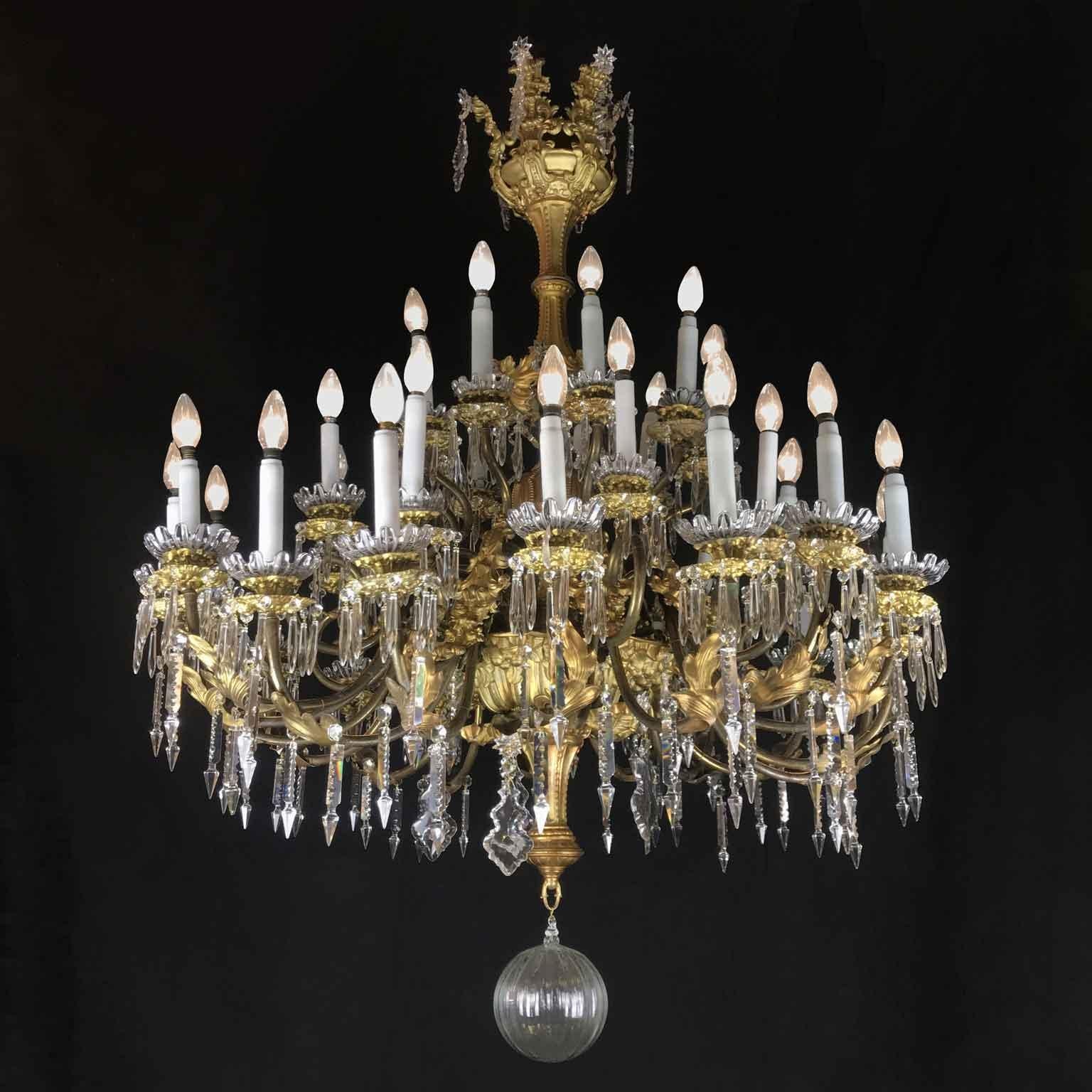 Monumental Italian antique chandelier, a 19th century gilt and crystal chandelier of Sicilian origin, a 36 lights, three-tiered repoussè and gilt brass leafted chandelier in good condition, ready to hang in your living room. This stunning antique